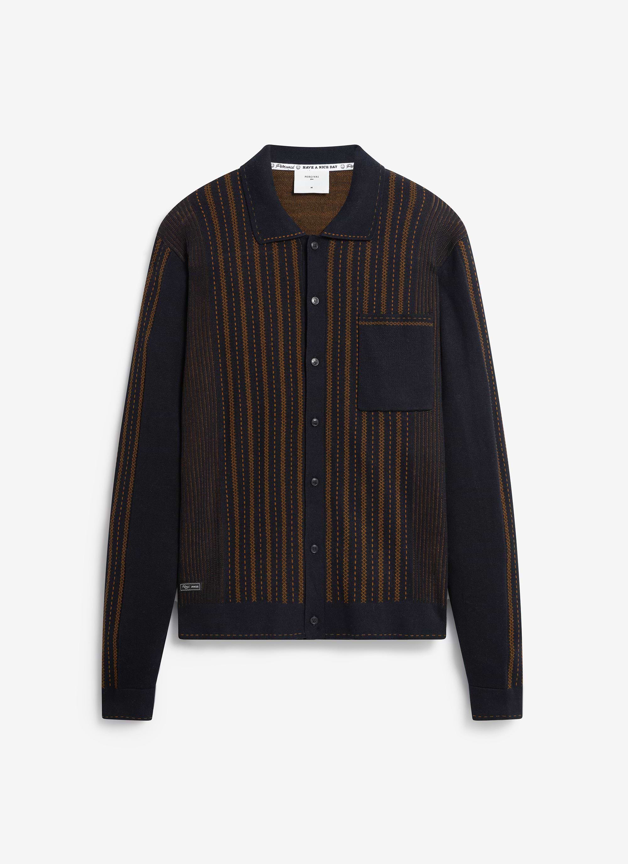 The Percival Appendix long-sleeve knitted shirt in black with a brown book spine-inspired jacquard design, shot flat.