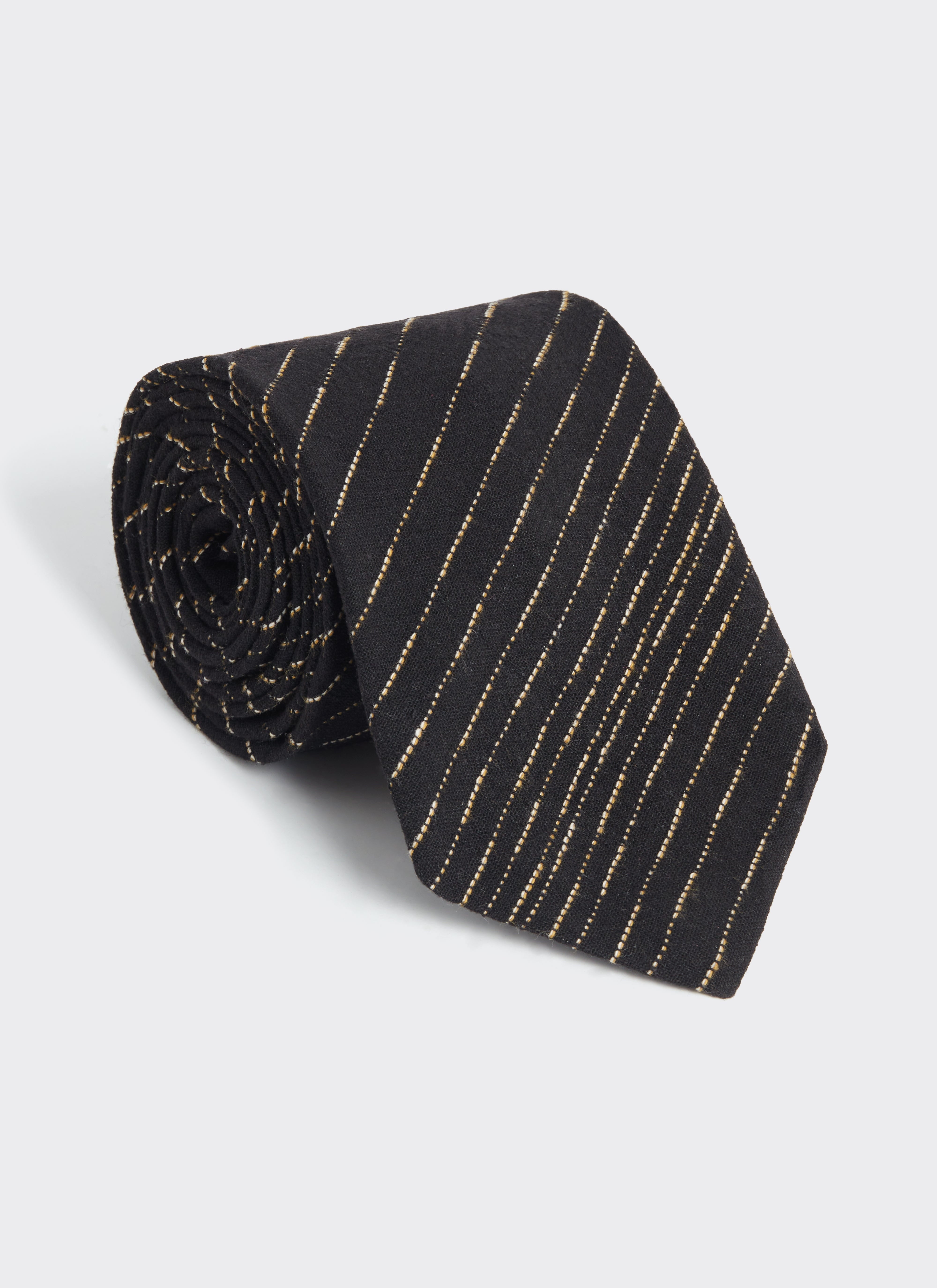 Rolled up view of the black cotton Percival Leland Tie, featuring a thin white dashed stripe pattern throughout.