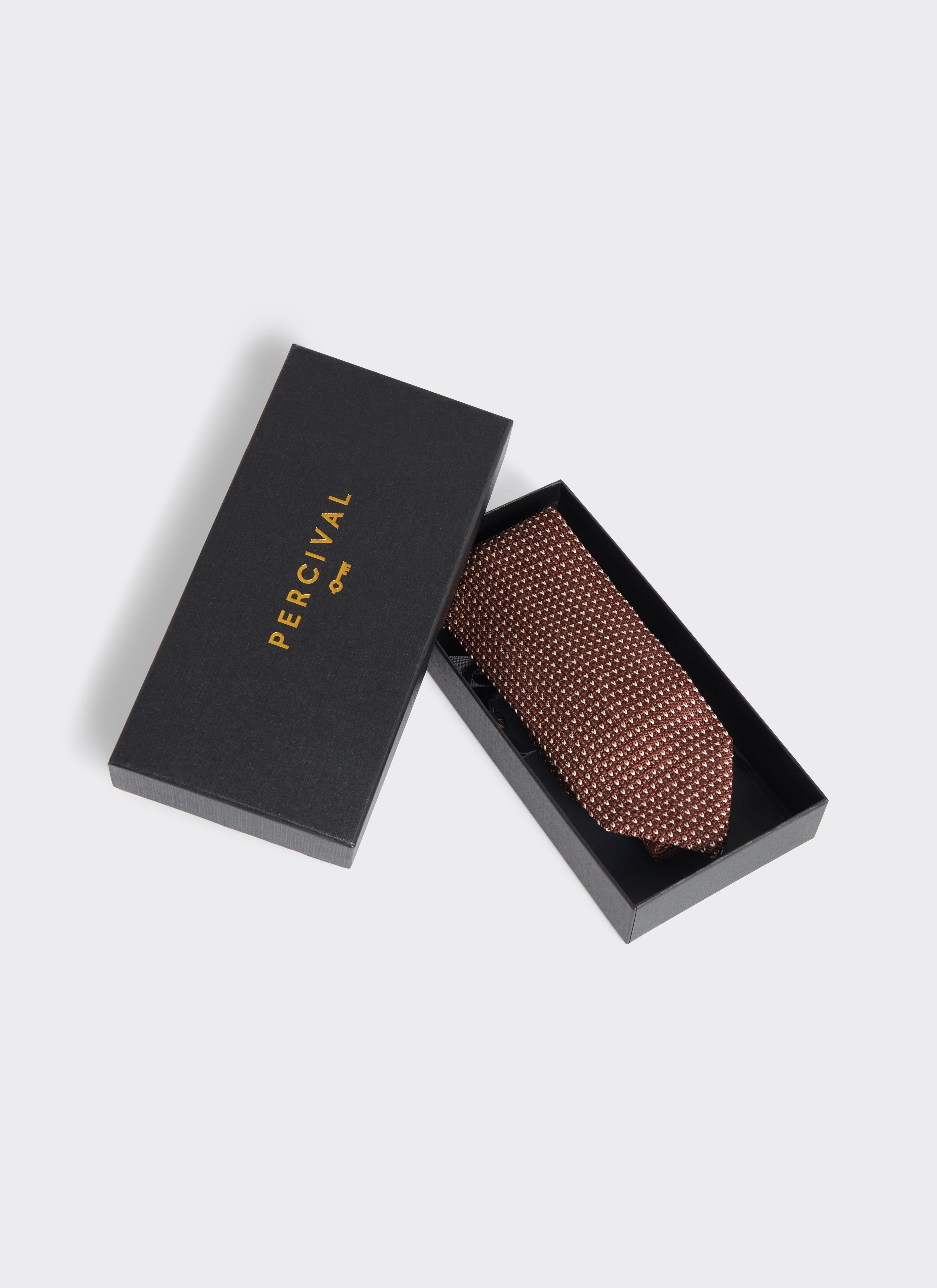 Percival espresso brown silk Birdseye Tie presented in a black branded gift box with a gold logo.