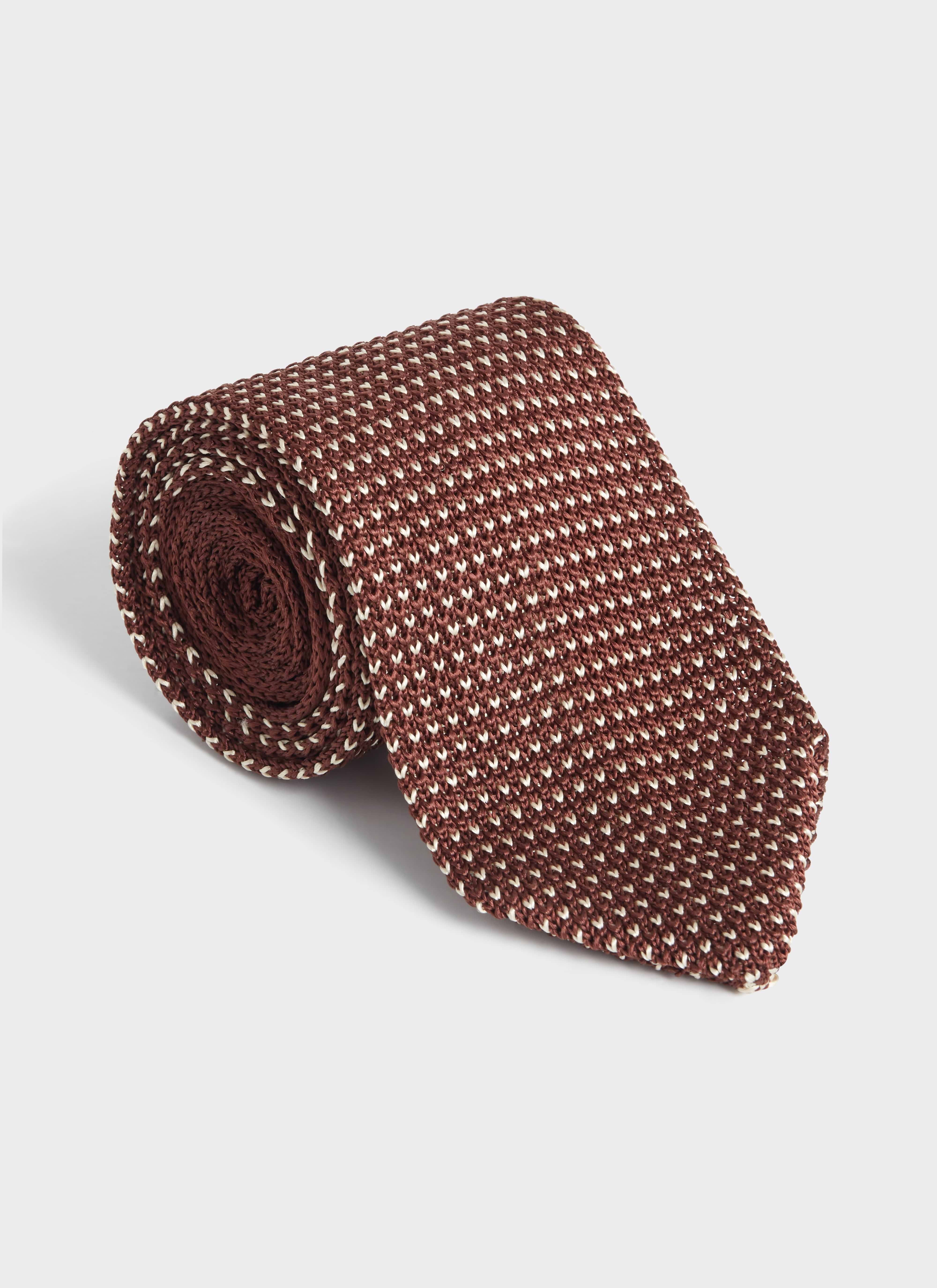 A rolled Percival Birdseye Tie in espresso brown 100% silk, showing the intricate textured weave and rich colour.