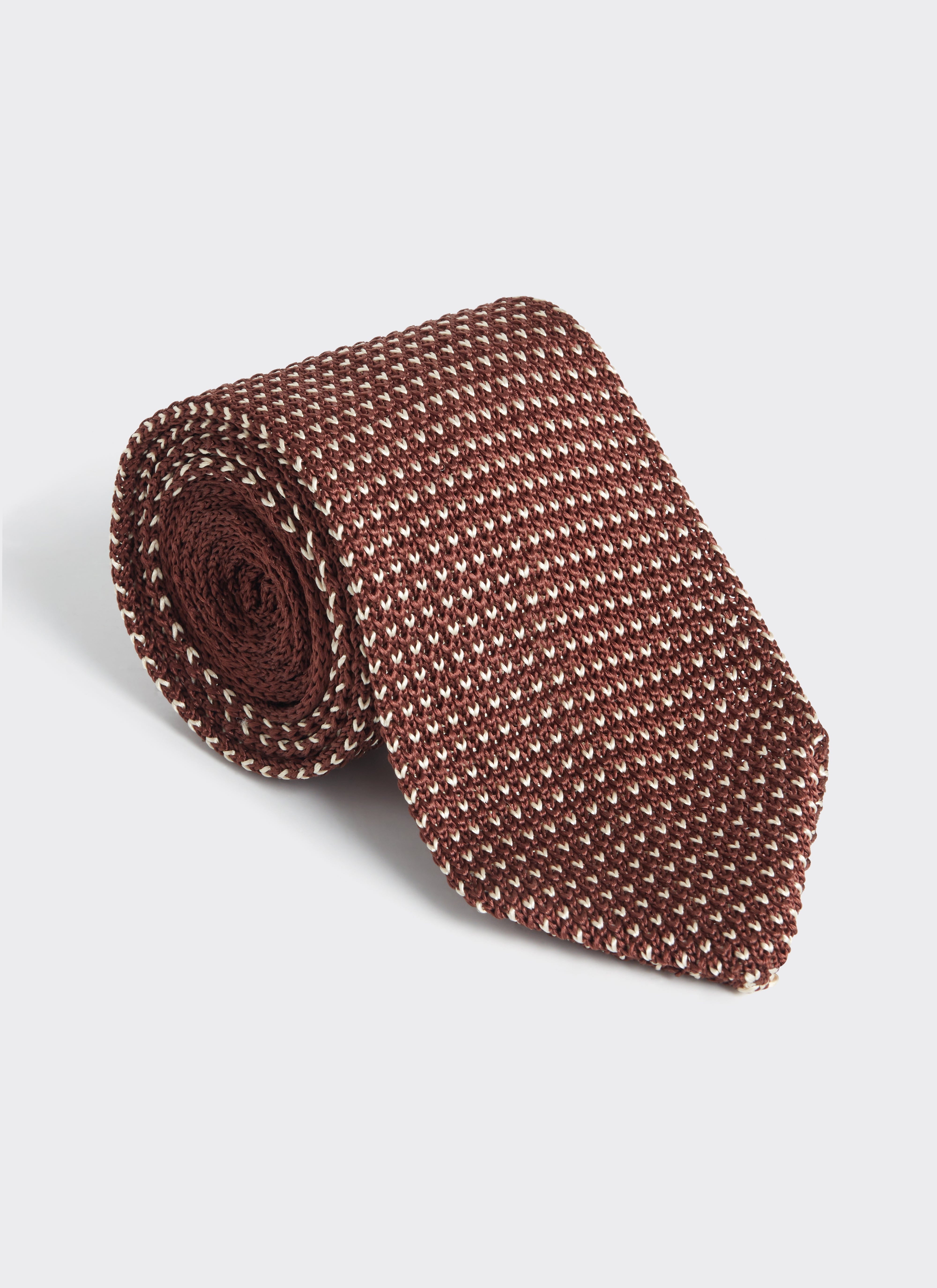 A rolled Percival Birdseye Tie in espresso brown 100% silk, showing the intricate textured weave and rich colour.