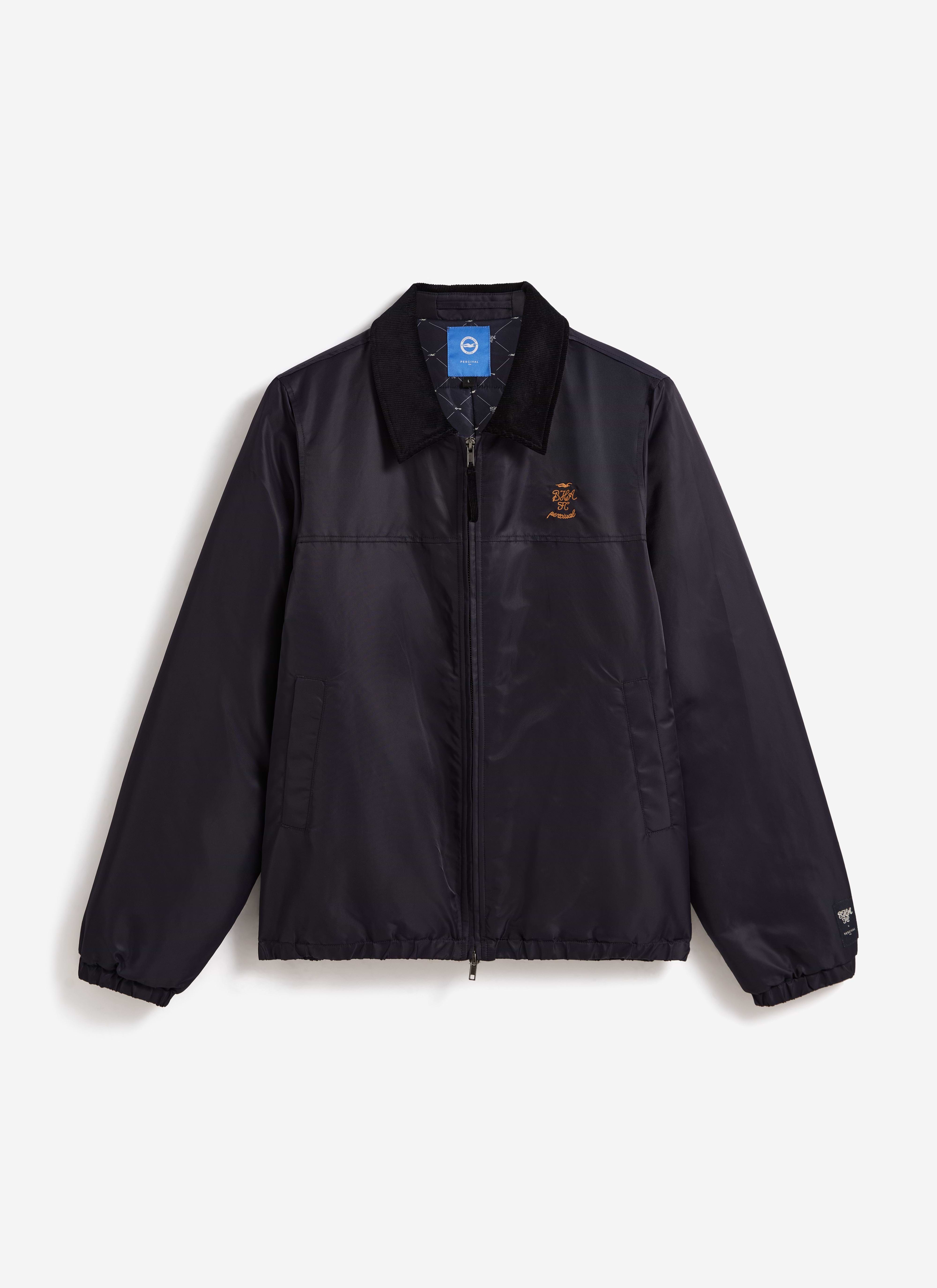 Front view of the navy Percival x Brighton & Hove Albion F.C. Coach Jacket, showing the cord collar and chest embroidery.