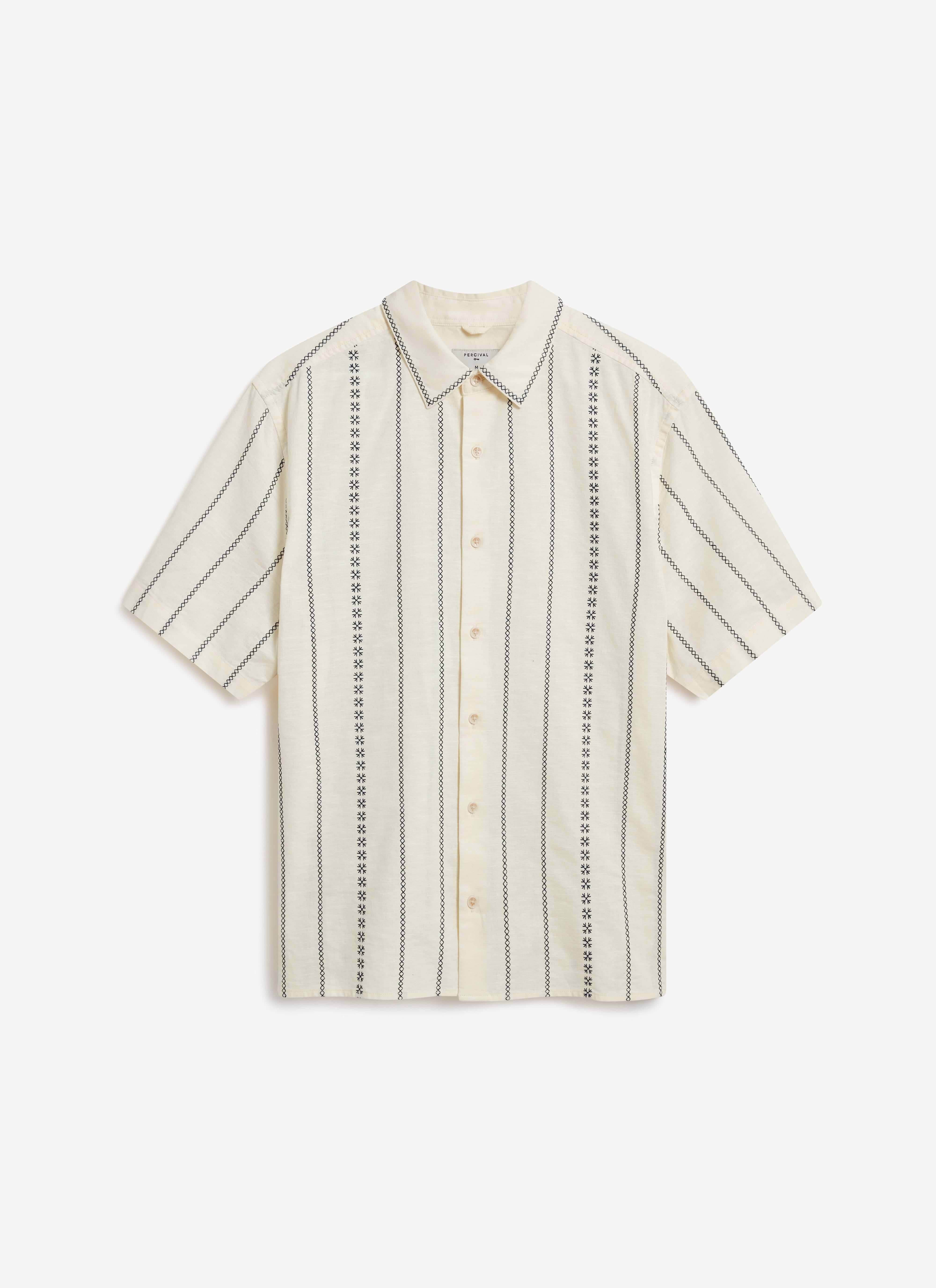 Front view of the Percival Cross Stitch Boxy Clerk Shirt in ecru, featuring its unique vertical embroidered pattern.
