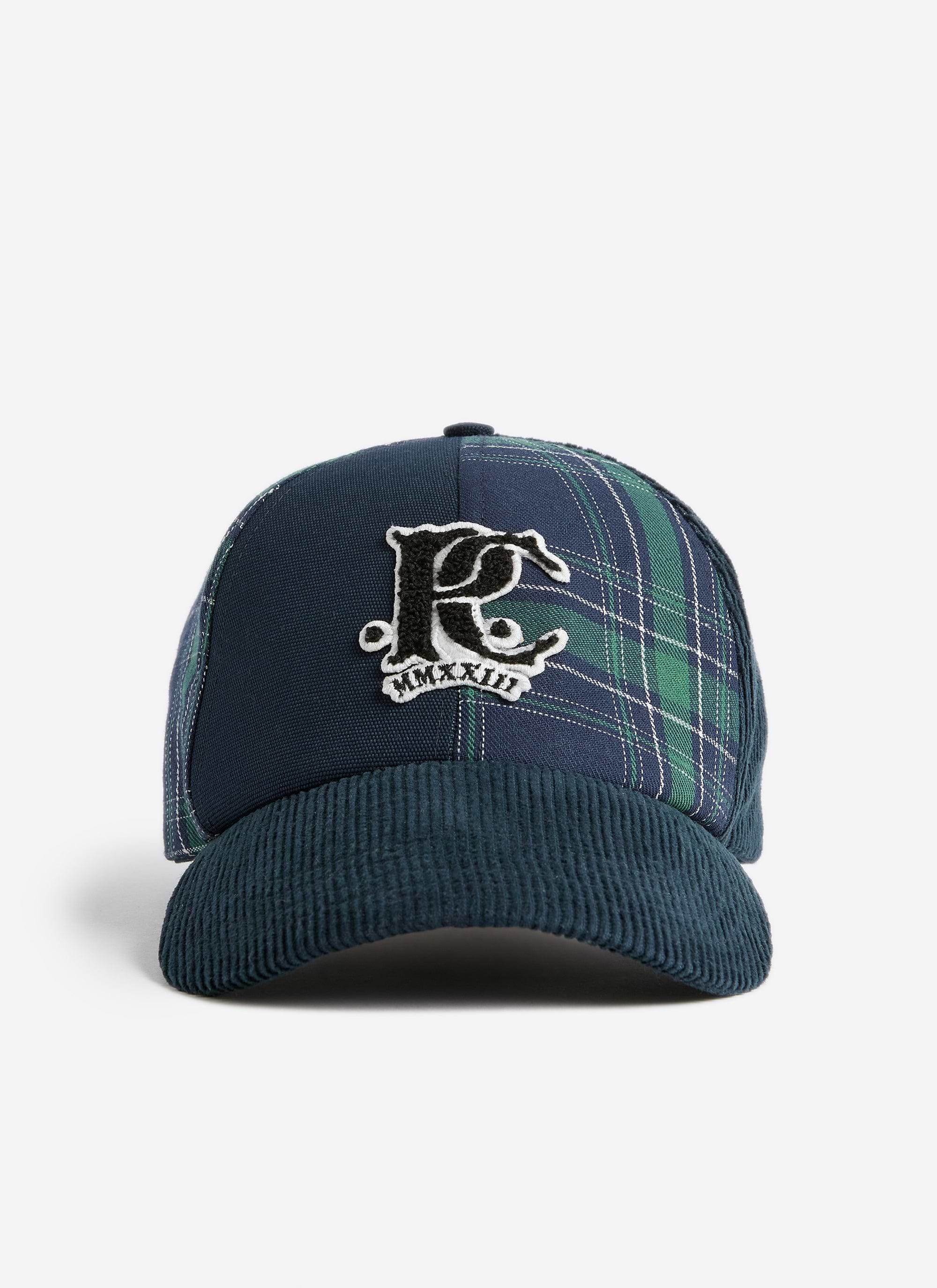 The Cut and Sew Cap from the Champion x Percival collaboration, featuring navy cord, tartan panels and a chenille P logo.