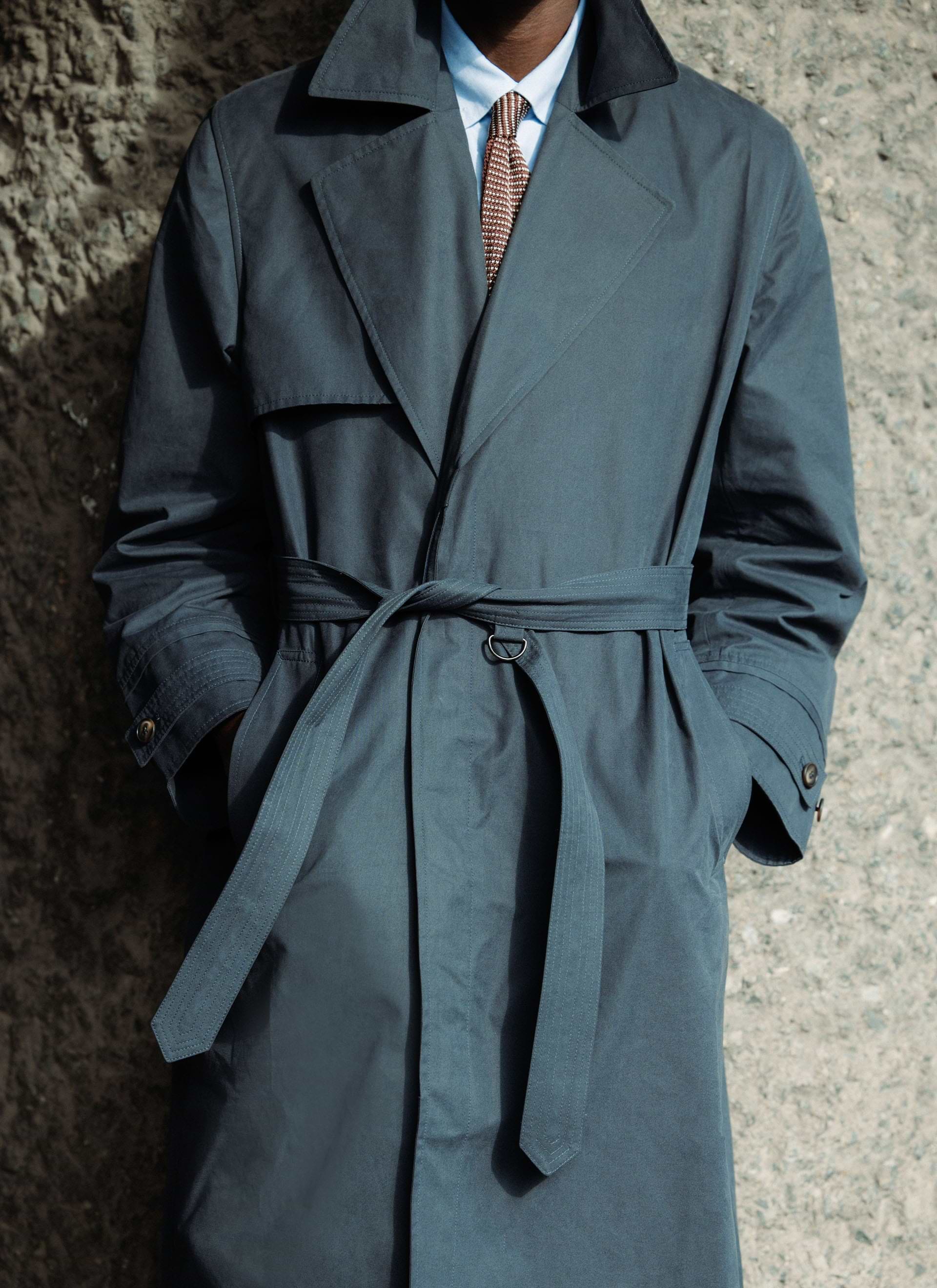 Navy peached cotton Mac Coat from the Front Office x Percival collection, showing the belted waist and cuff detail.