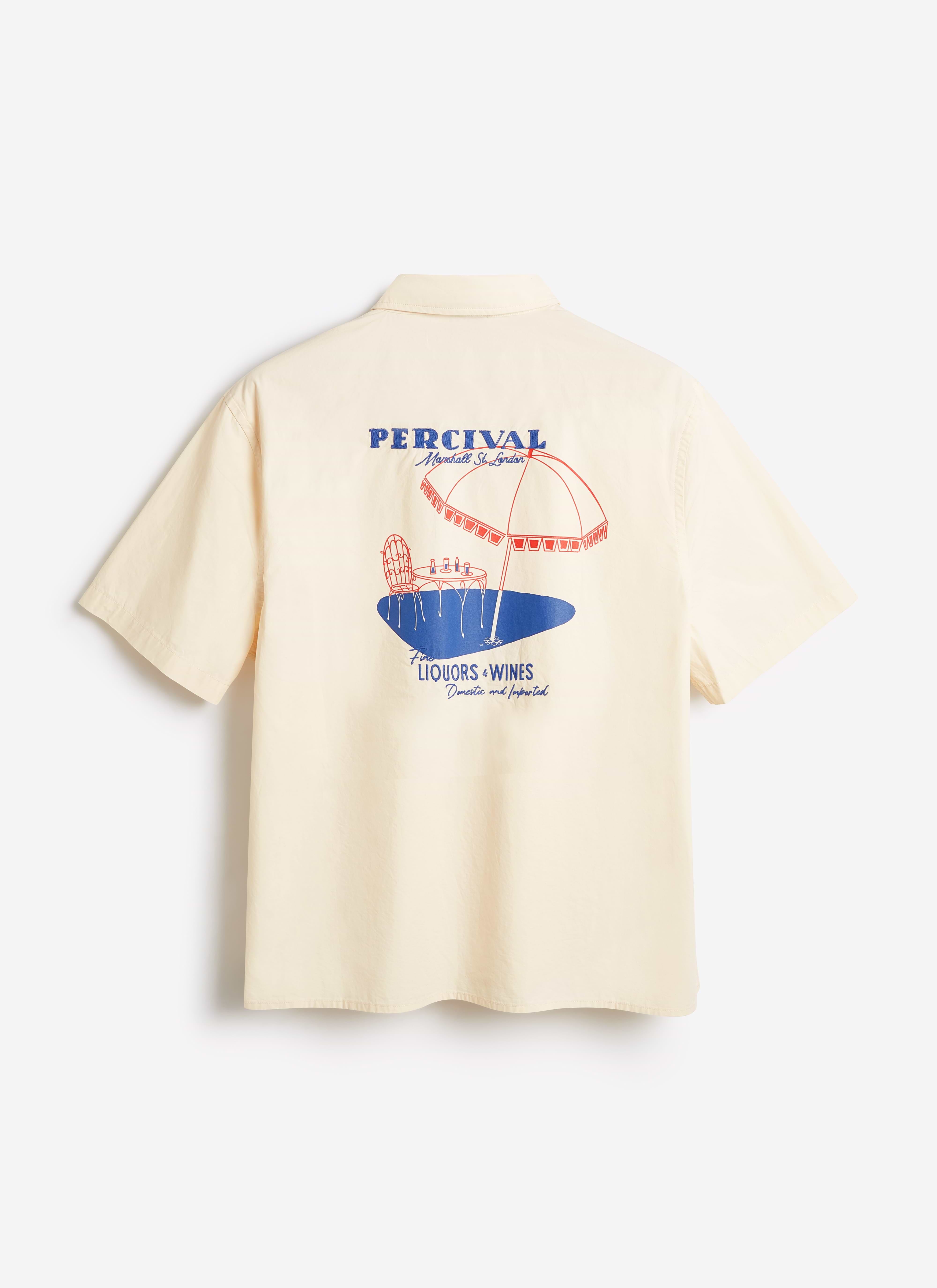 Back view of the Percival Harlow Boxy Shirt in ecru cotton, featuring a large red and blue embroidered beach scene.