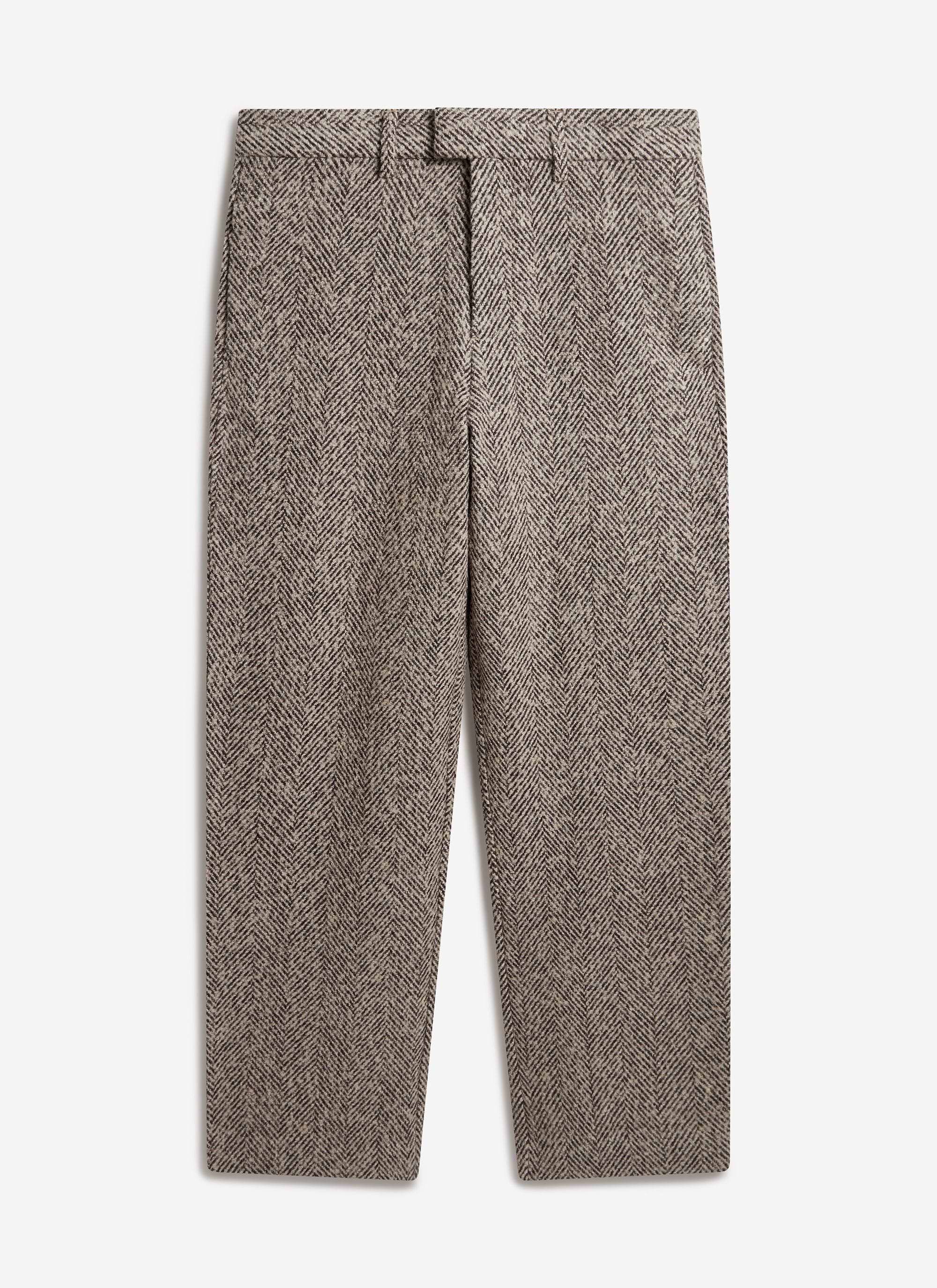 A flat lay photograph of the straight-leg Herringbone Trousers in ecru by Percival, made from a textured wool blend.