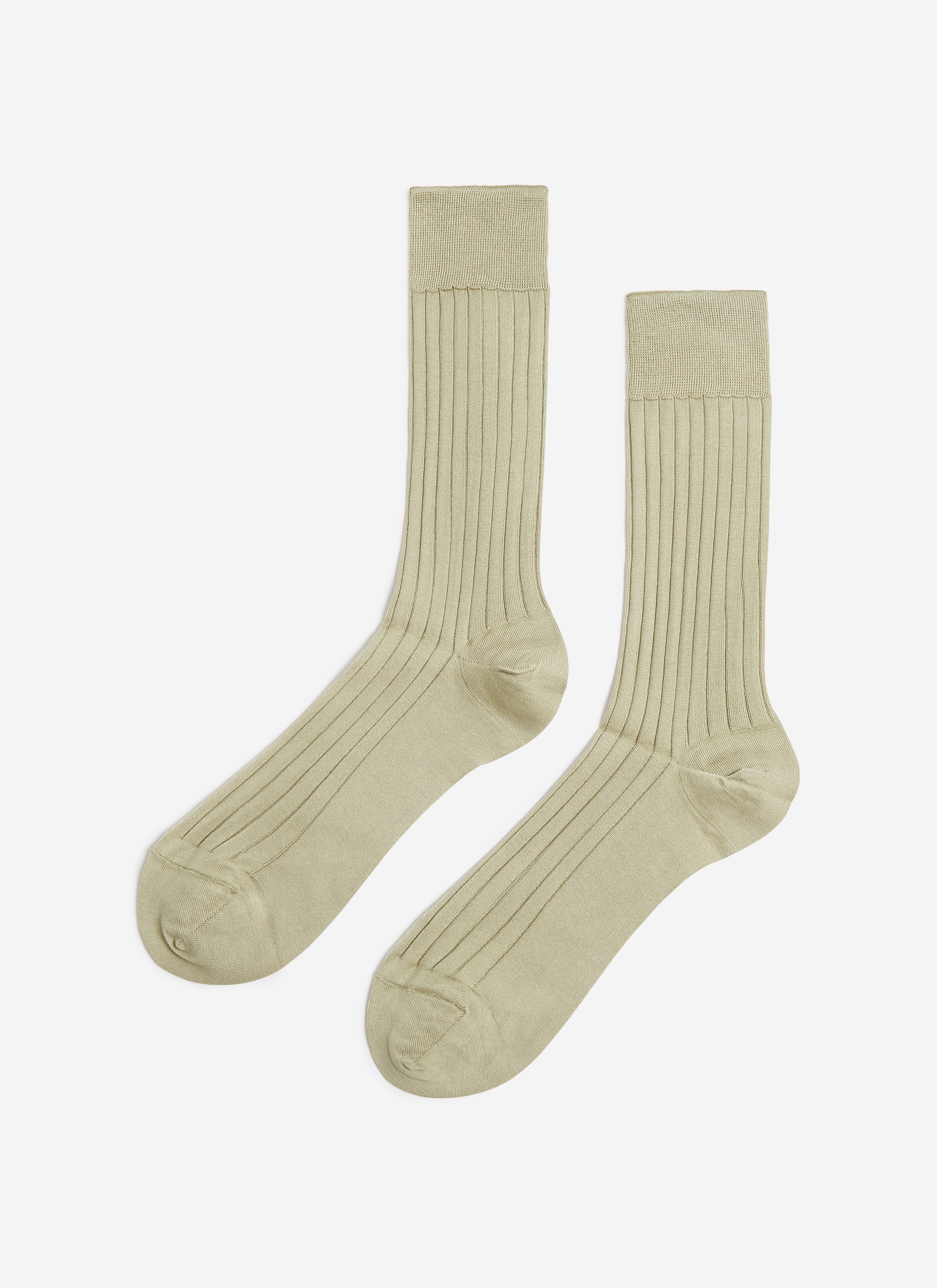 A flat lay of the Percival Loafer Dress Socks in sage green, showing the ribbed cotton texture.