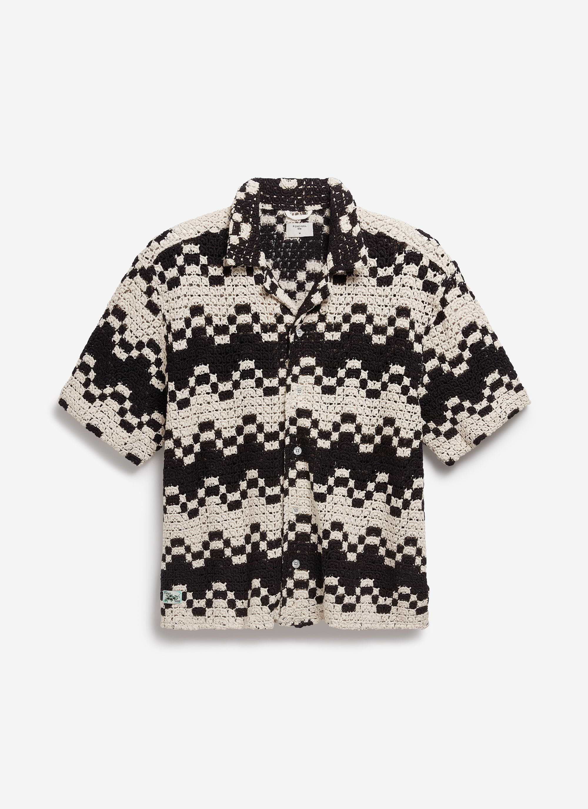 Front view of the Percival Naples Crochet Cuban Shirt in ecru, laid flat to showcase the intricate black geometric crochet.