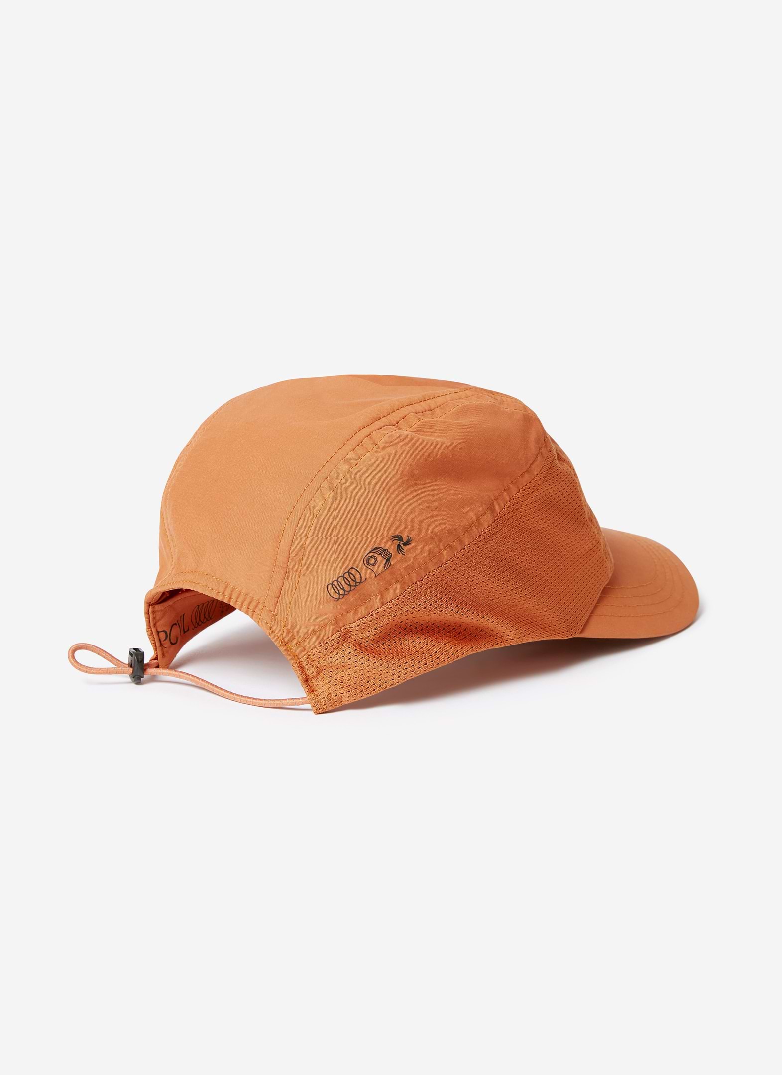 A side profile of the PCVL Nylon Cap in rust by Percival, showing the mesh panelling and adjustable toggle at the back.