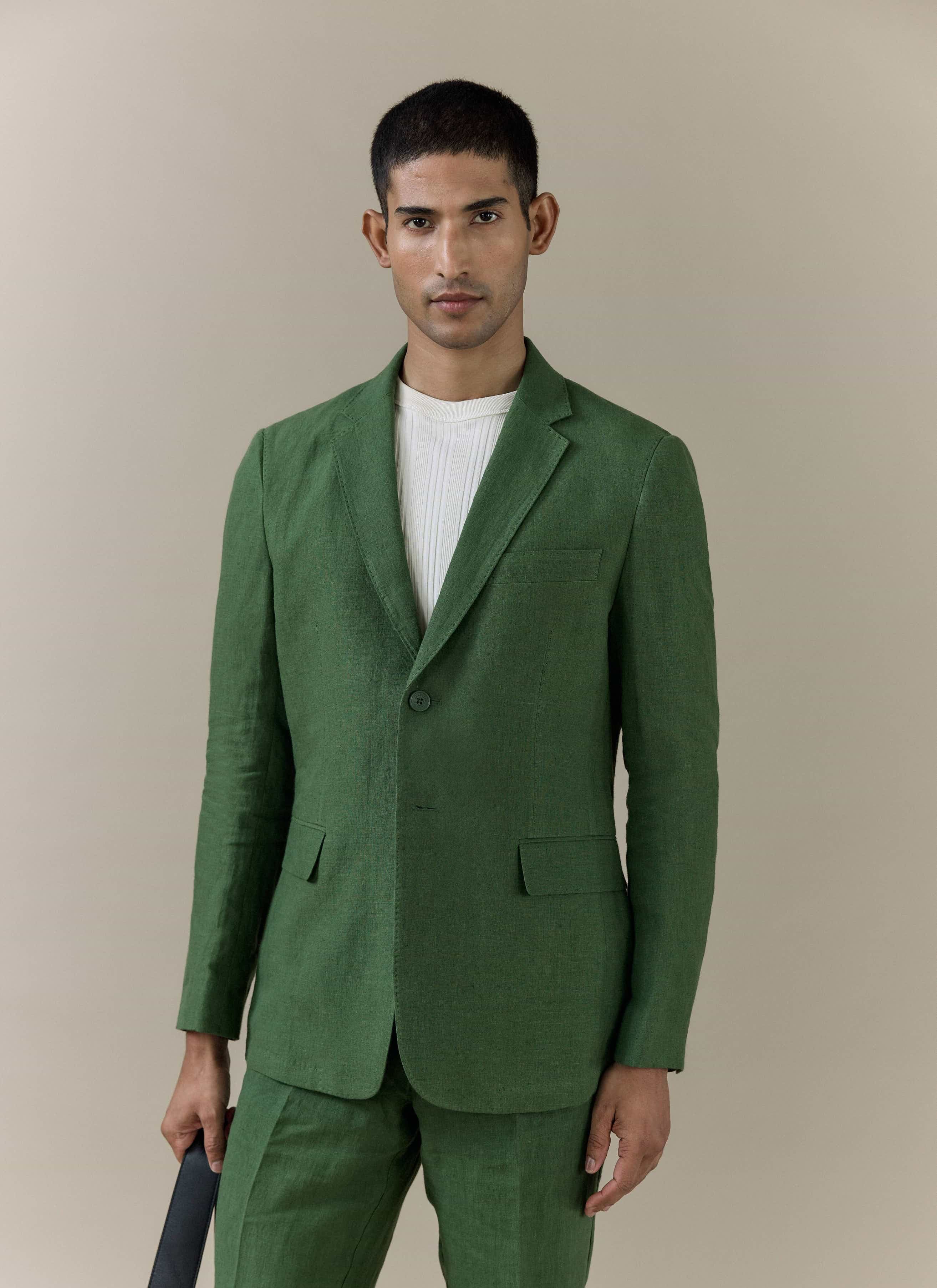 A model wearing the forest green Percival Slim Fit Classic Blazer in breathable linen against a neutral backdrop.
