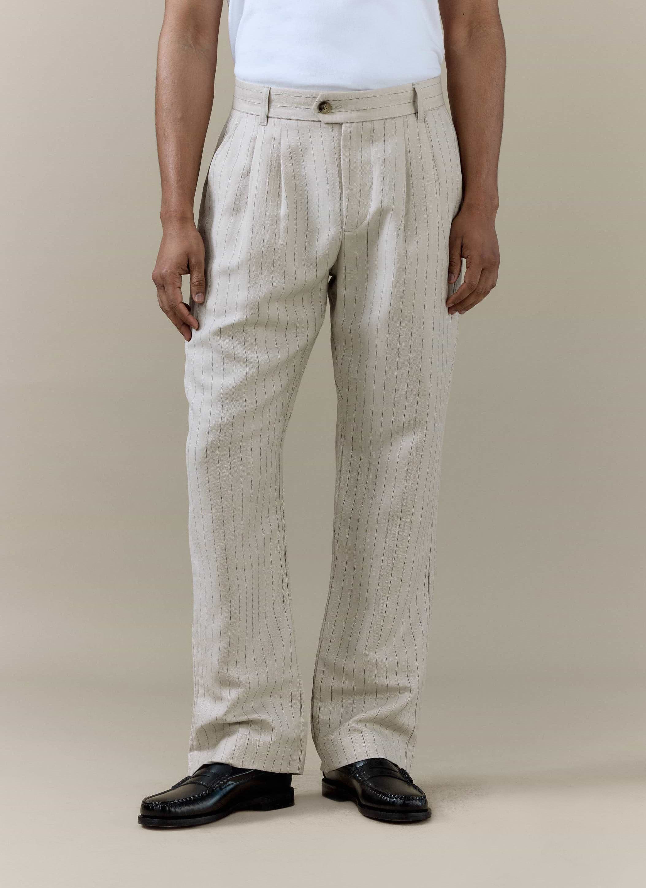 Percival cream striped pleated tailored trousers in a linen blend, worn by a model with black leather loafers.