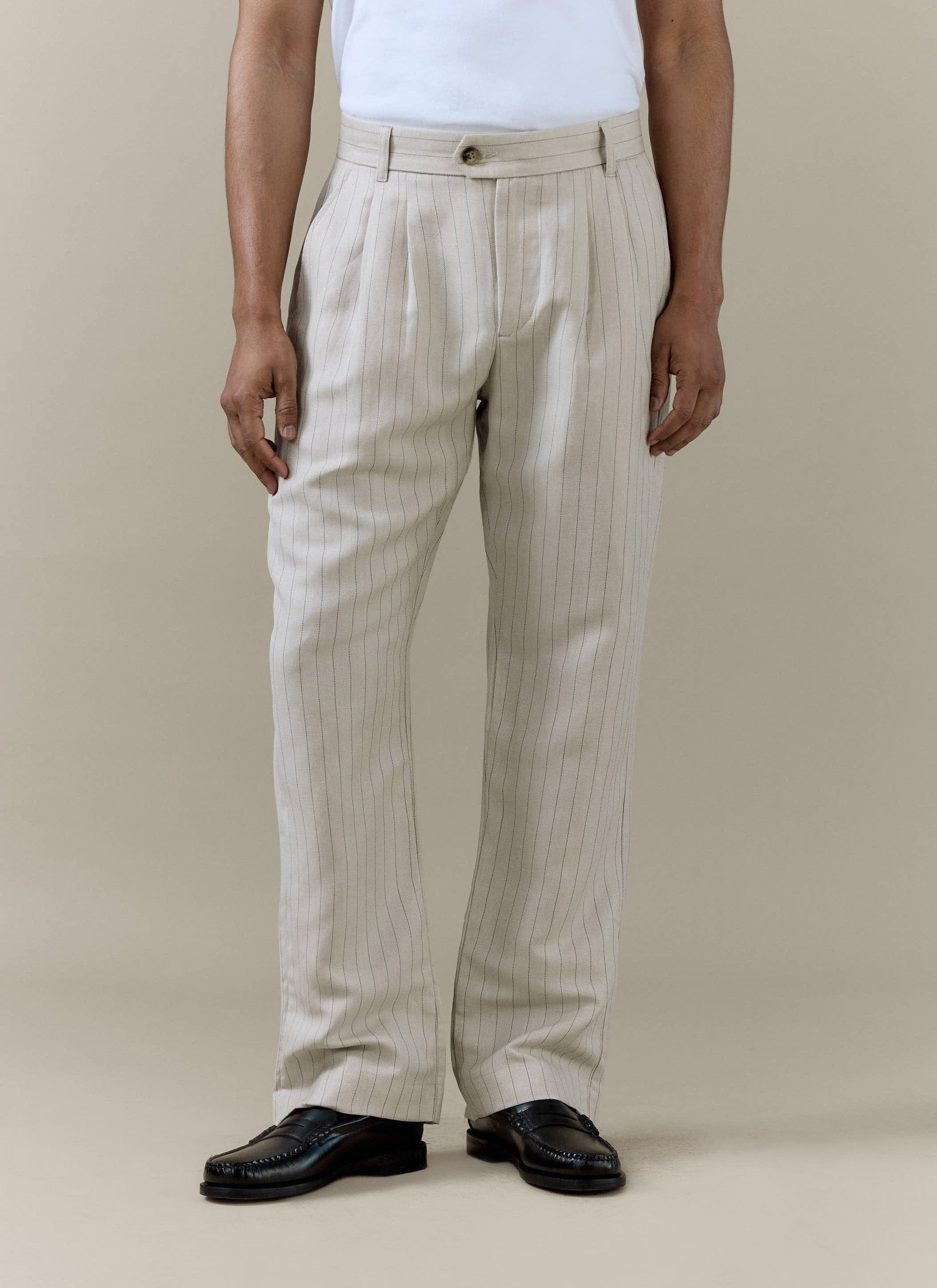 Percival cream striped pleated tailored trousers in a linen blend, worn by a model with black leather loafers.