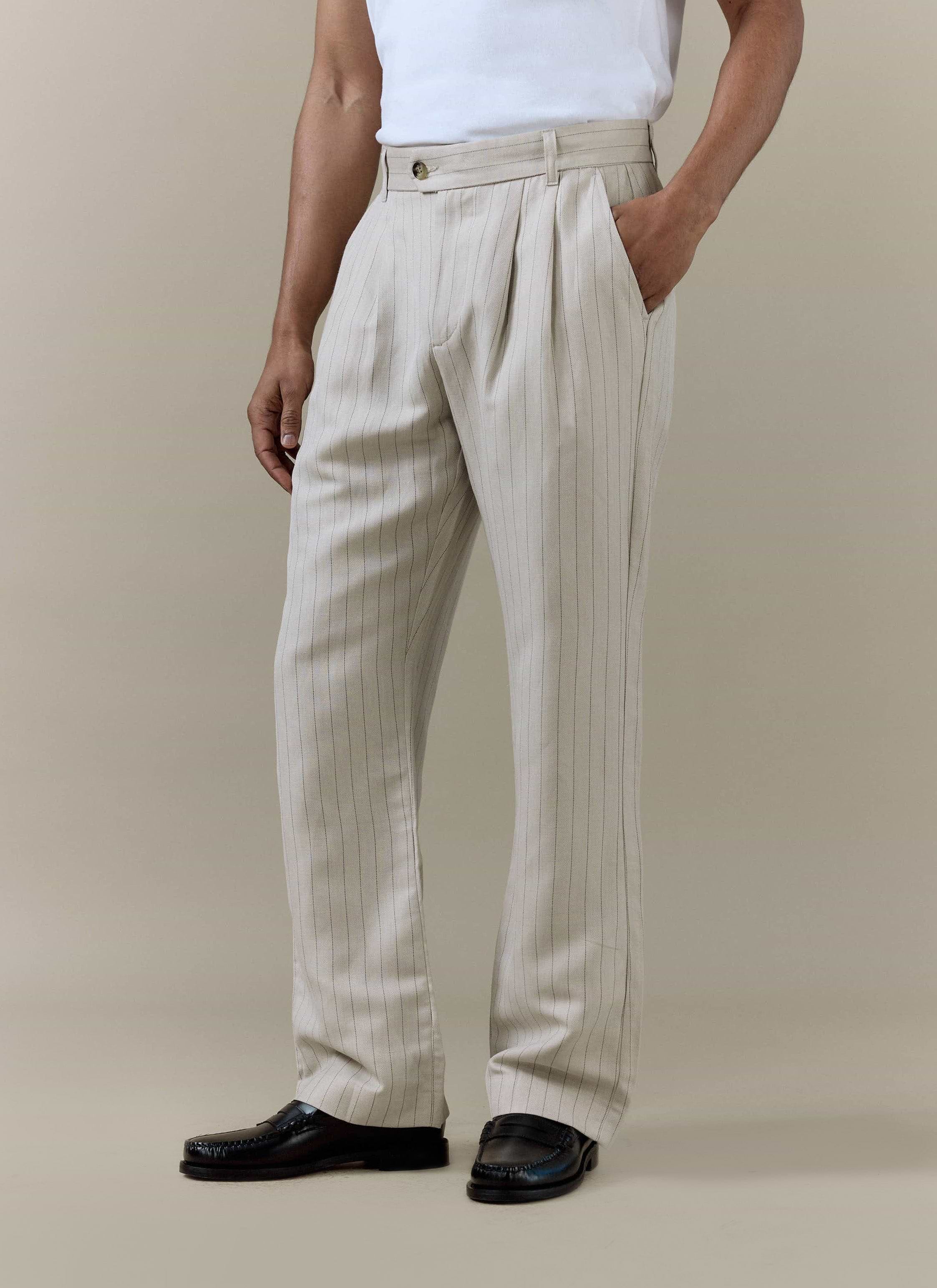 Percival cream striped pleated tailored trousers in a linen blend, styled with a white t-shirt and black loafers.