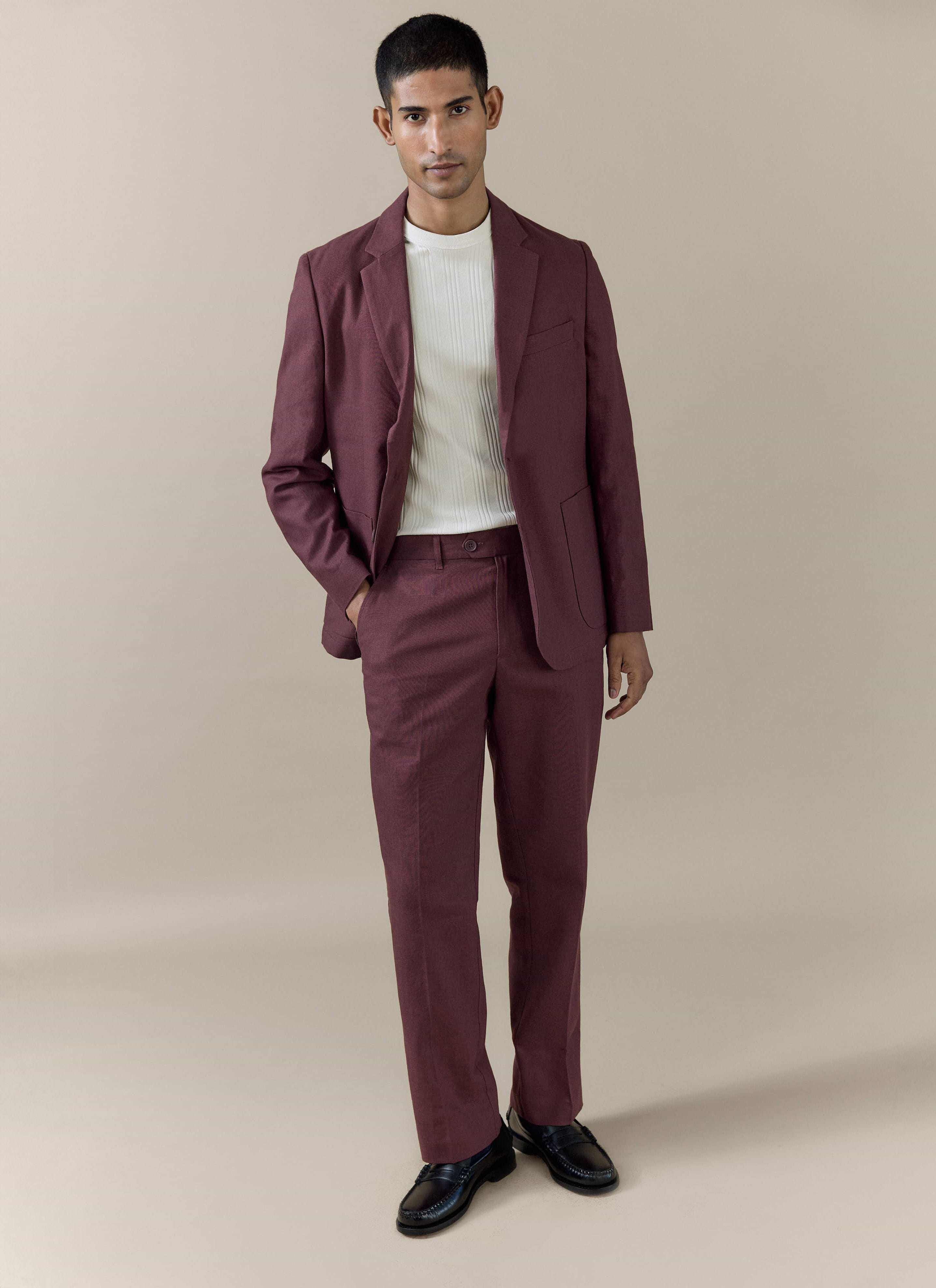 Percival tailored linen blazer in merlot, worn by a model with matching trousers and a white ribbed shirt.