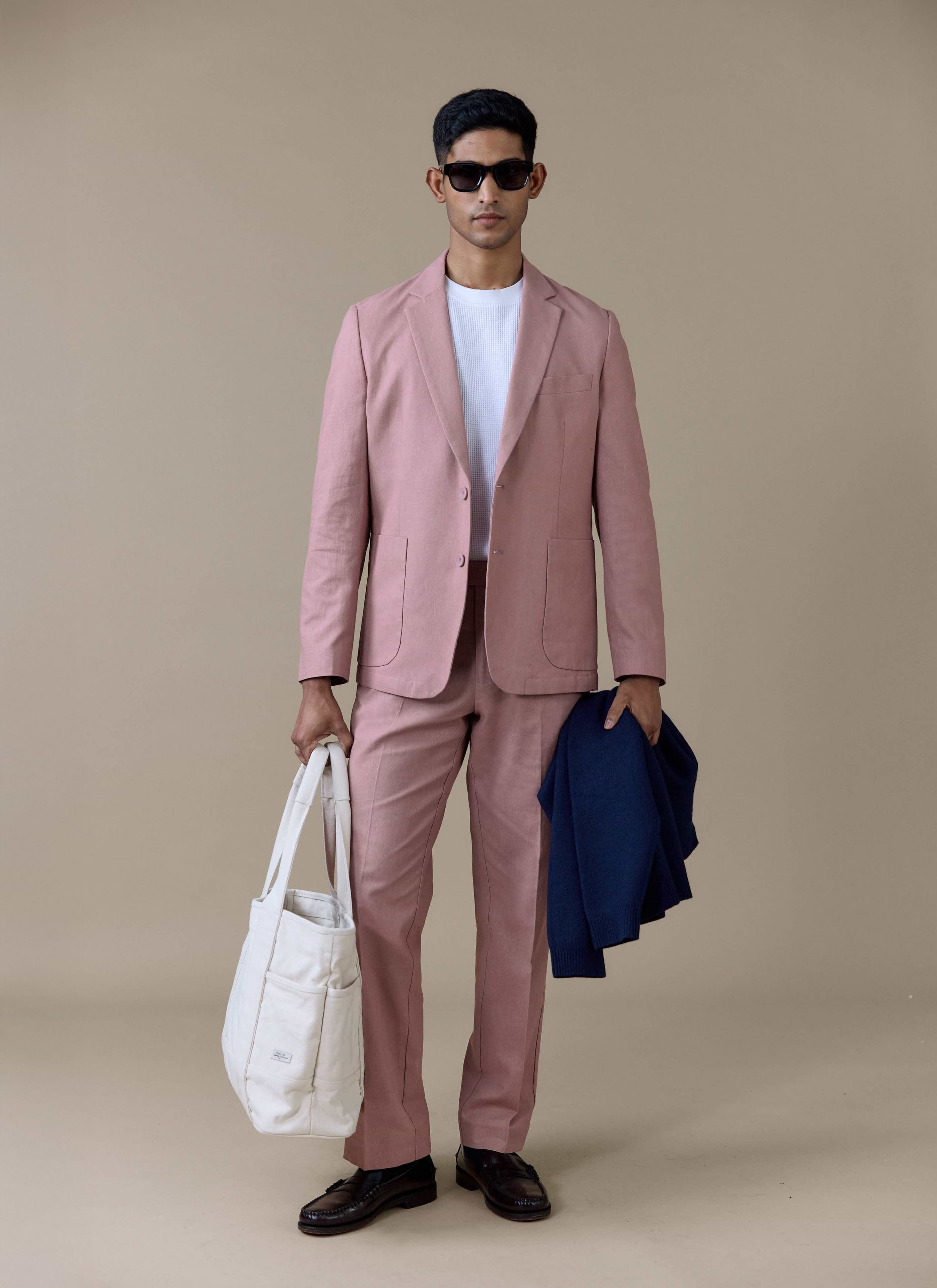 Percival Tailored Linen Blazer and matching trousers in Dusty Pink, styled with a white textured t-shirt and sunglasses.
