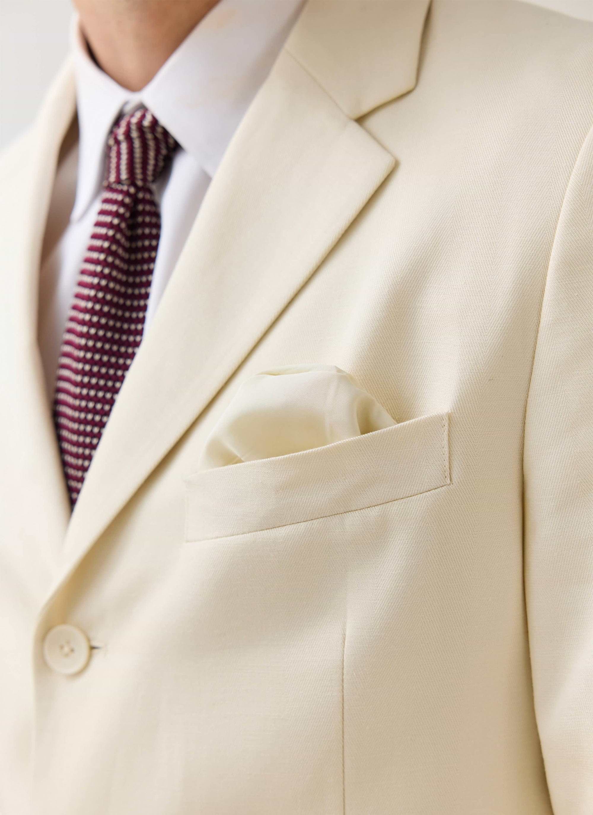Close-up of the Percival Clifton Blazer in cream, styled with a white shirt, burgundy tie and matching pocket square.