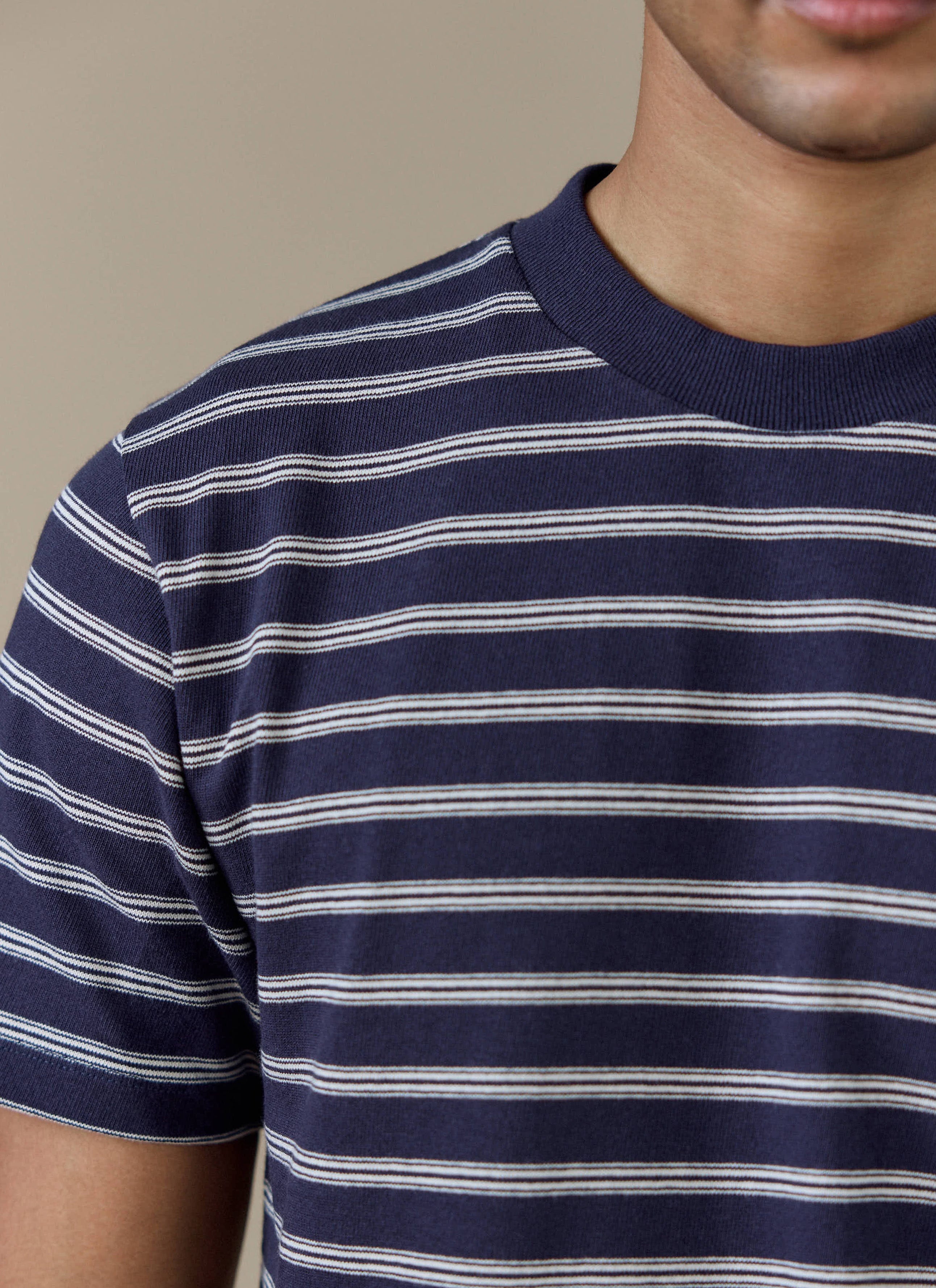 A close-up of the ribbed crew neck and navy Breton stripe pattern on the Arlo T-shirt from Percival.