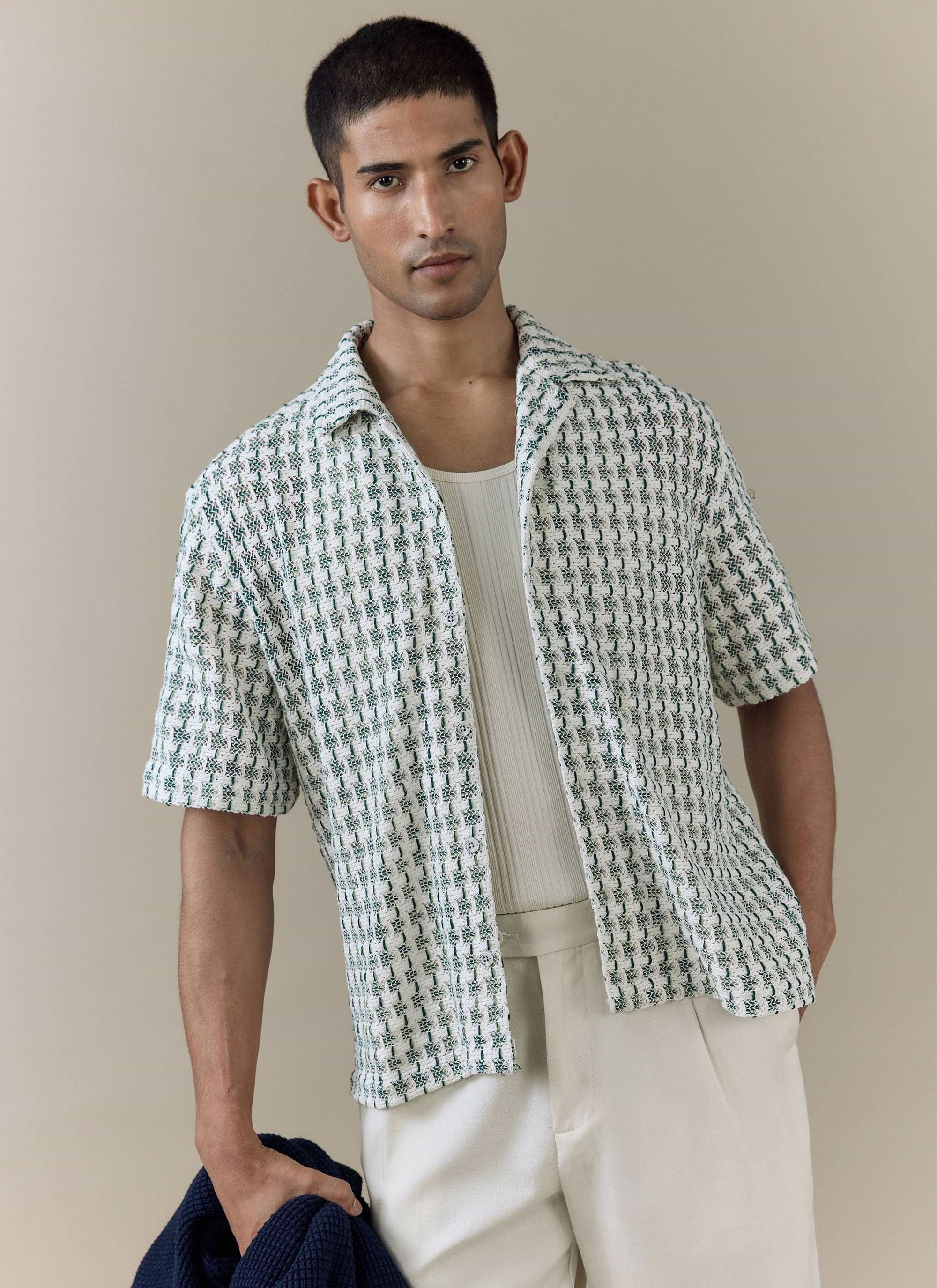 The green textured Percival Freddie Crochet Boxy Shirt worn by a model, featuring a cotton-blend open knit pattern.