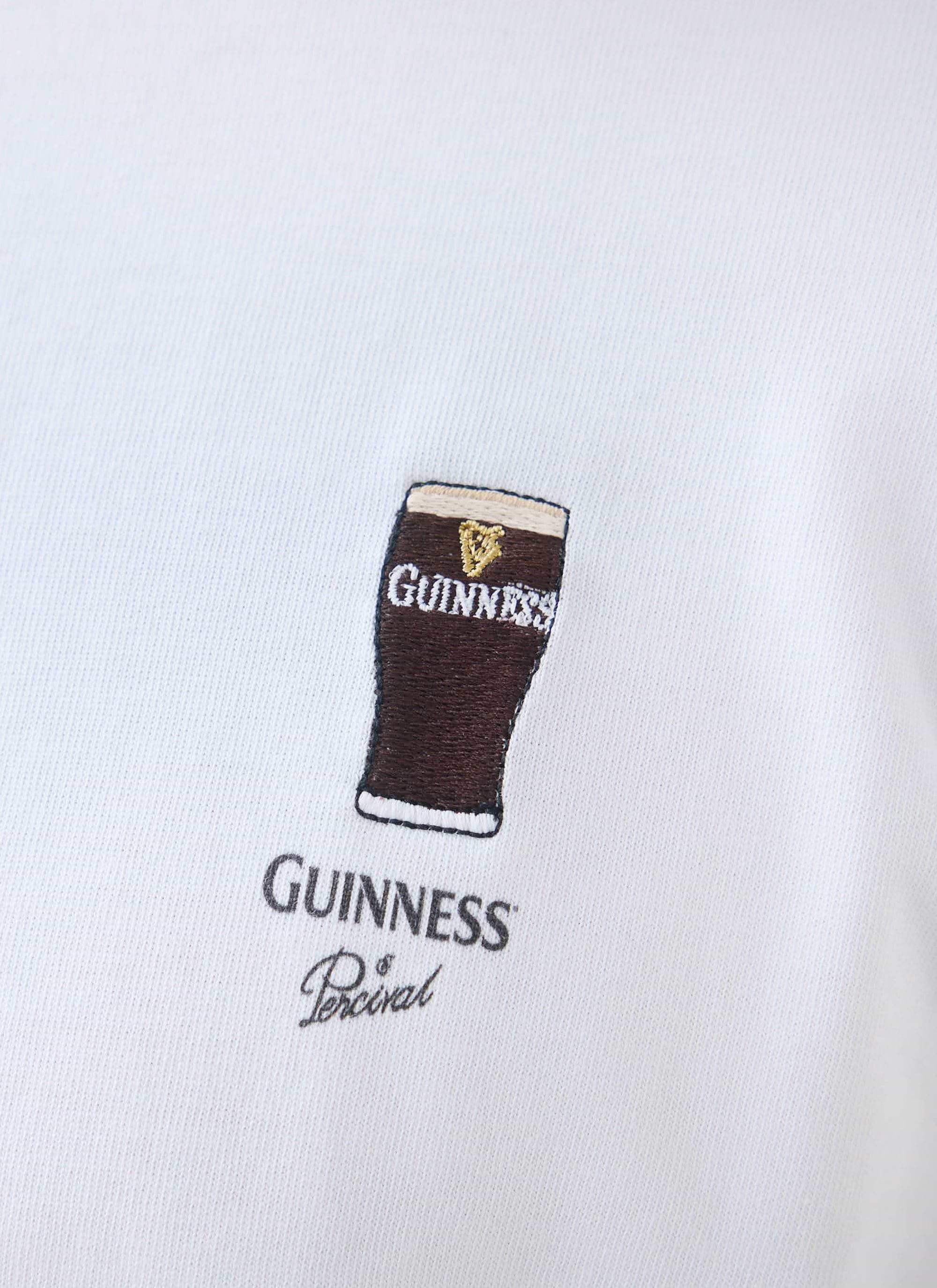 Close-up shot of the chest embroidery on the white Percival x Guinness Stout T-Shirt, featuring a pint of stout.
