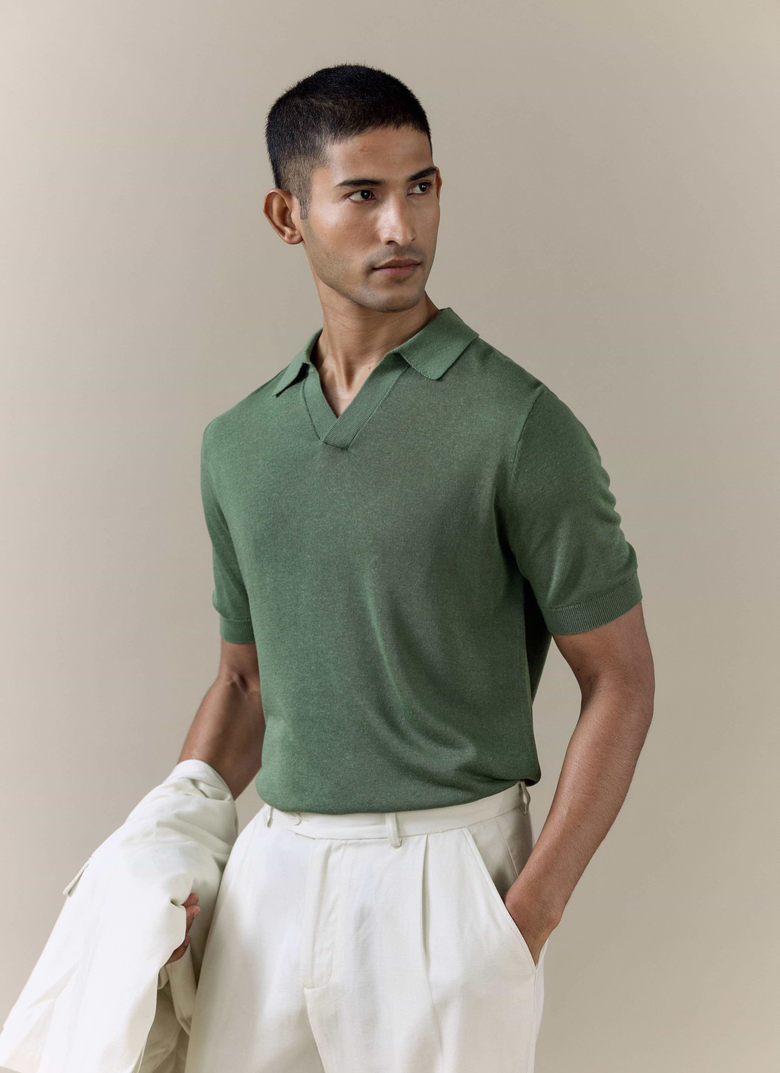 Percival Laurence Knitted Polo in forest green linen lyocell blend, styled with cream trousers on a model.