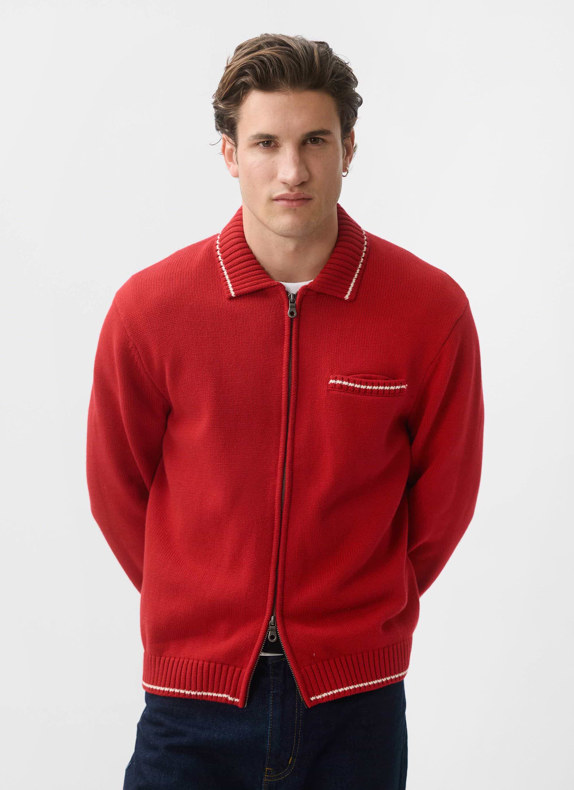 A model wears the Percival Gardner Dense Knitted Zip Cardigan in red, posing against a clean white studio background.