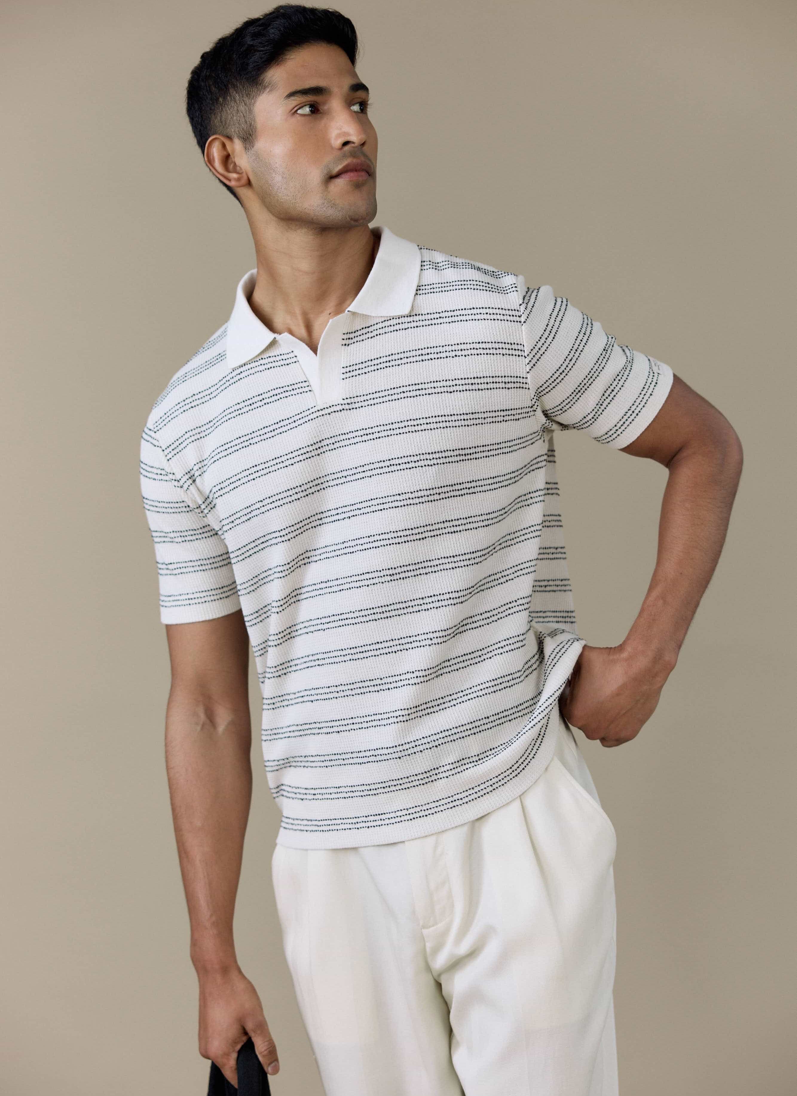 Model wears the Percival Laurent Boxy Polo in cream with a horizontal stripe and open collar.