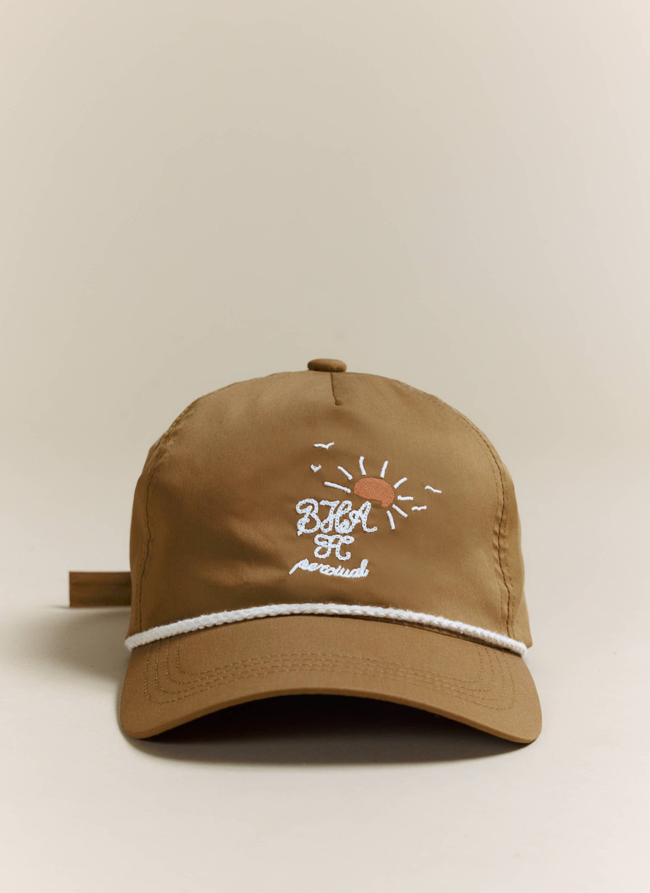 Front view of the Percival x Brighton & Hove Albion F.C. Trucker Cap in rust, showing the detailed front embroidery.