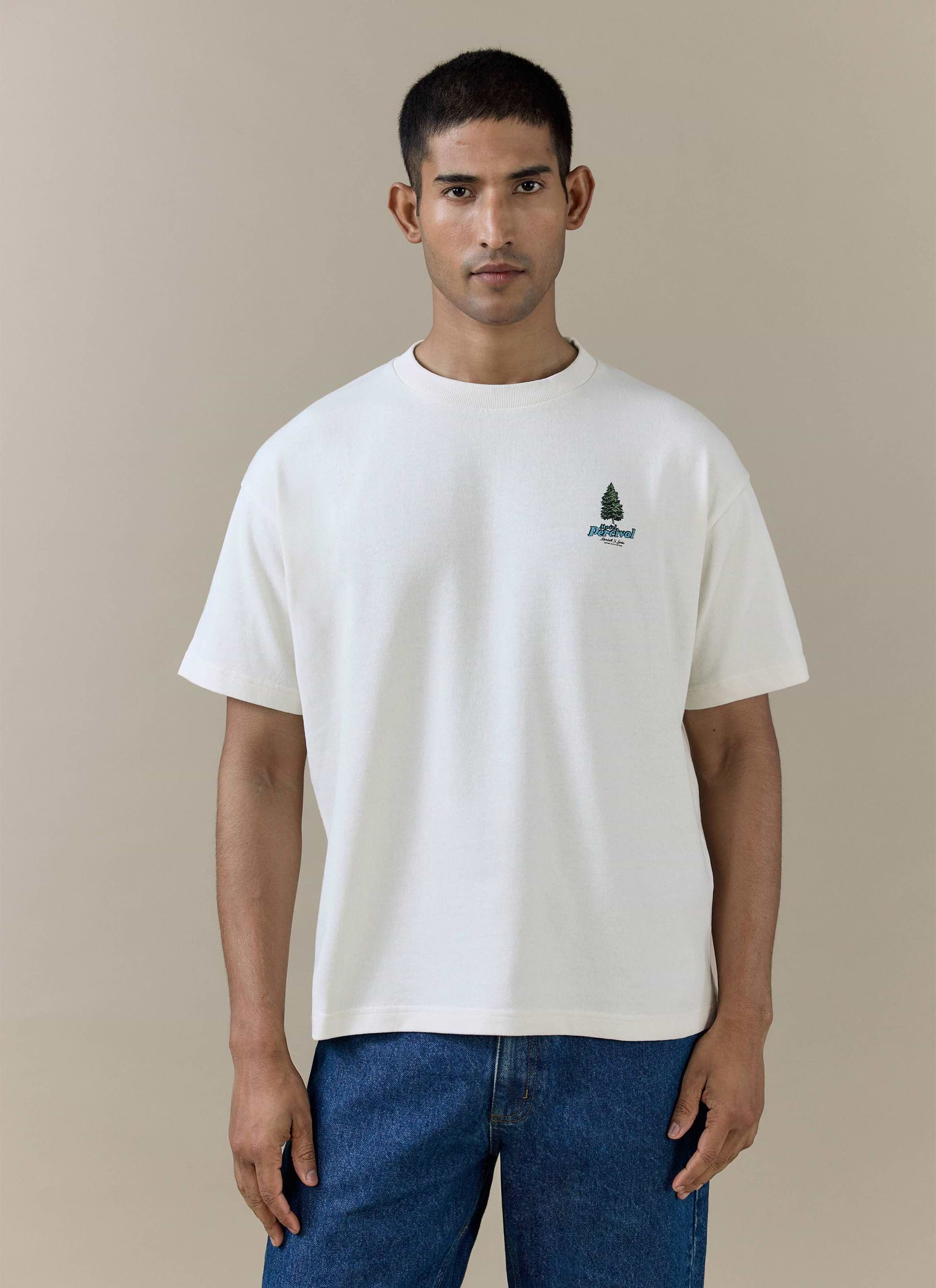 Percival Arnold Oversized T Shirt in cream organic cotton with a pine tree chest graphic, worn by a model.