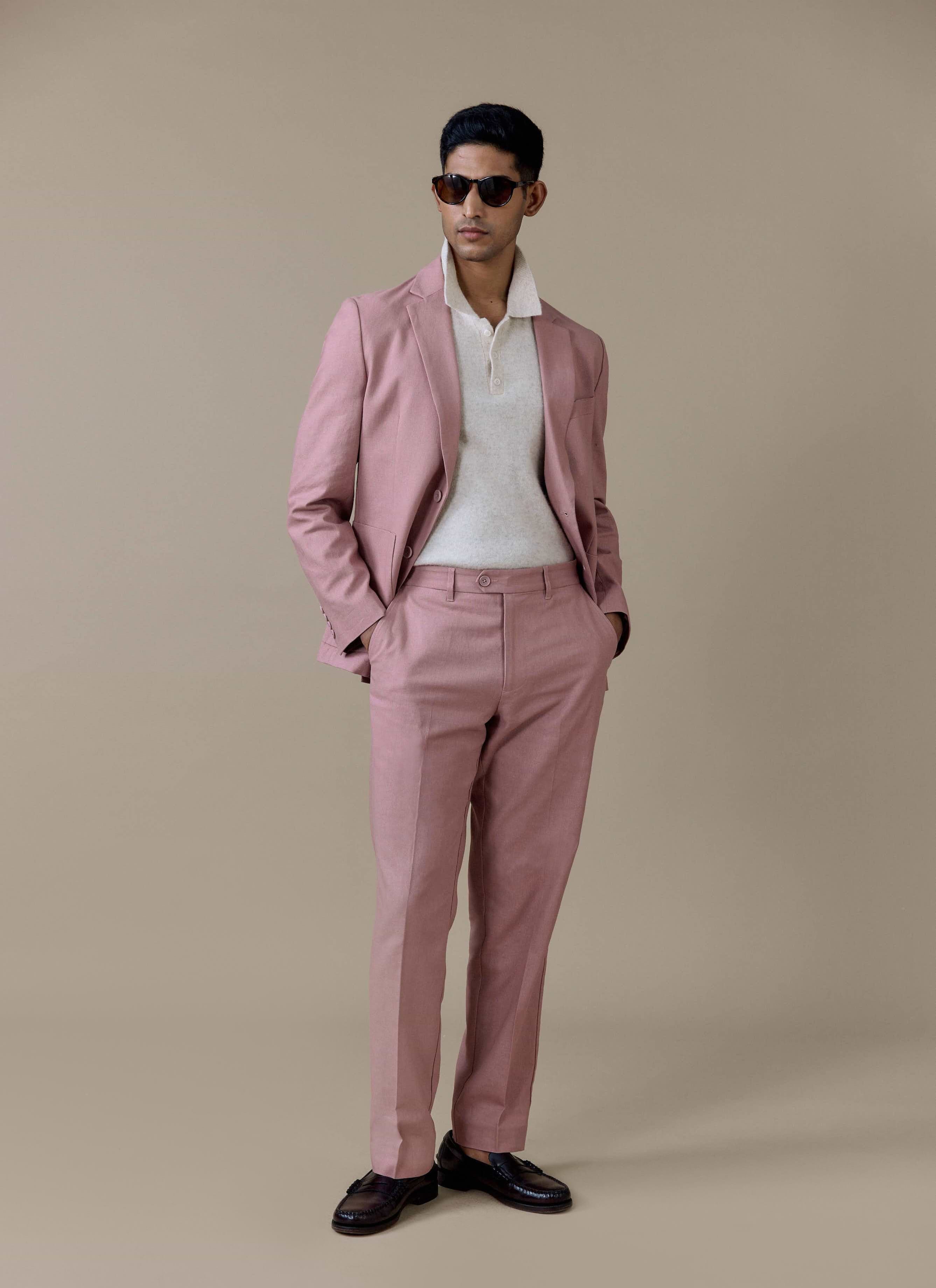 Percival tailored linen blazer in dusty pink styled with matching suit trousers and a cream knitted polo shirt.