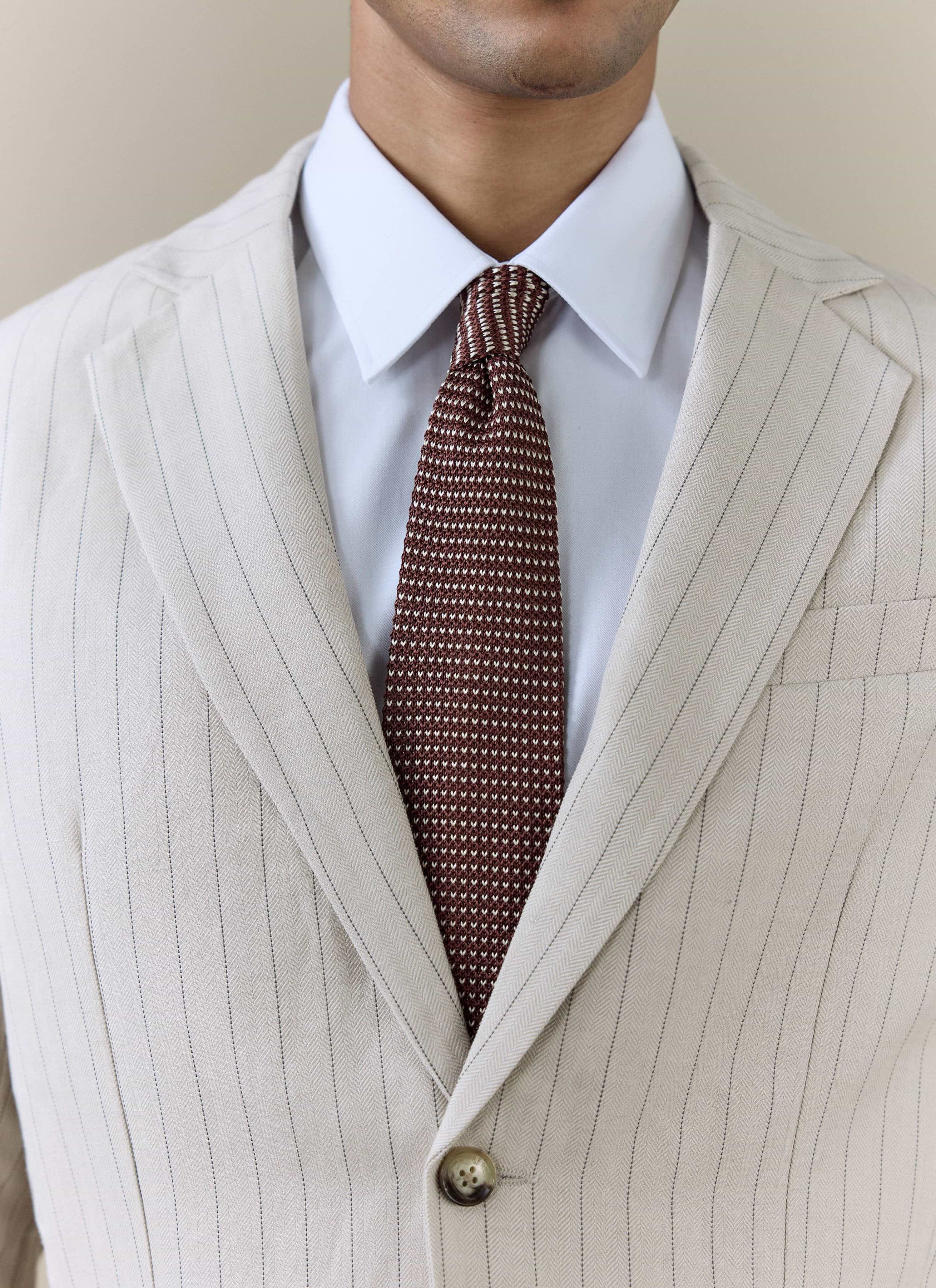 Percival Birdseye Silk Tie in espresso brown, styled with a white shirt and a cream pinstripe suit.