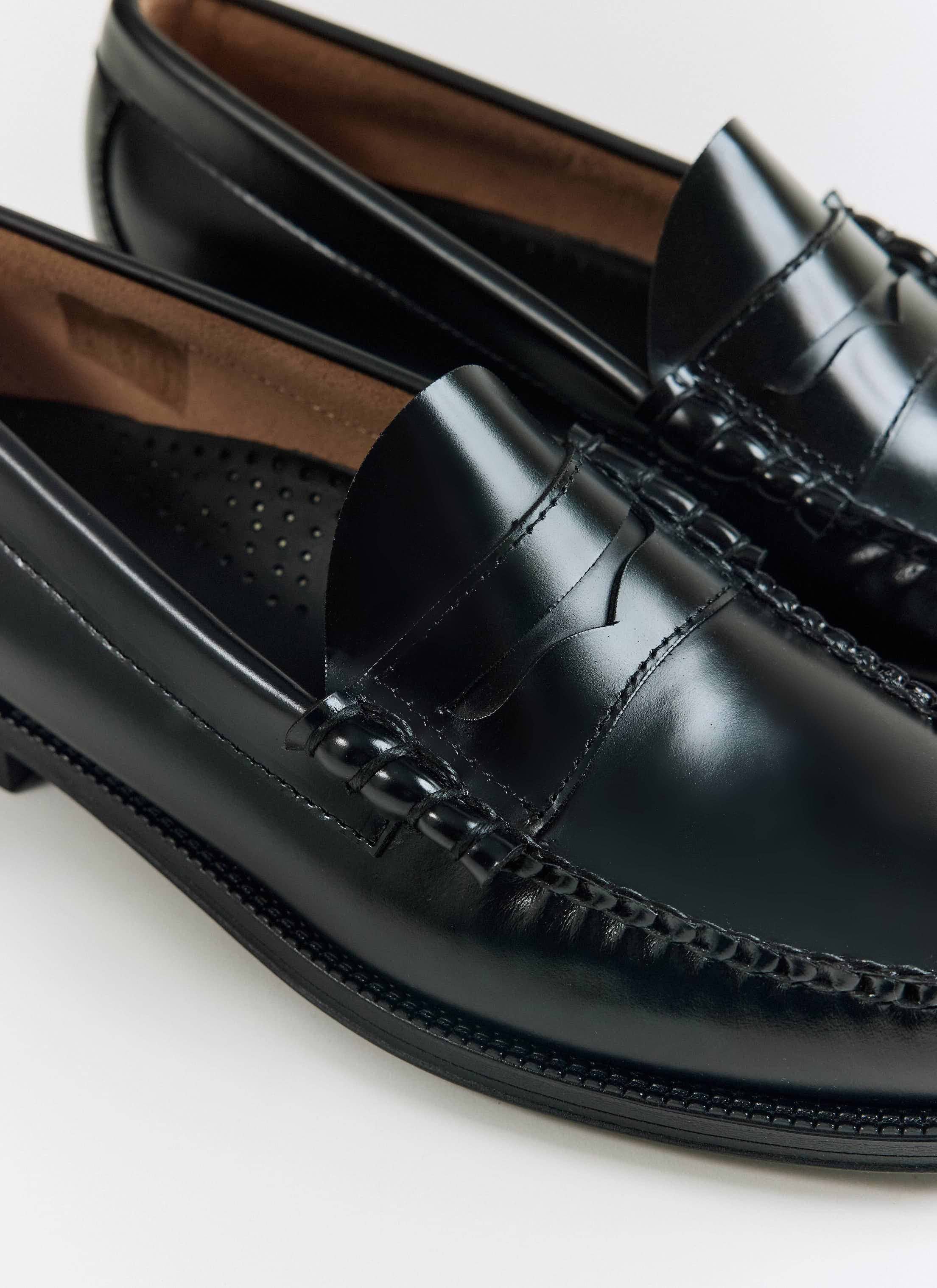 Close-up of the black G.H.Bass Weejun II Larson Moc Penny loafers, showing hand-stitched leather details at Percival.