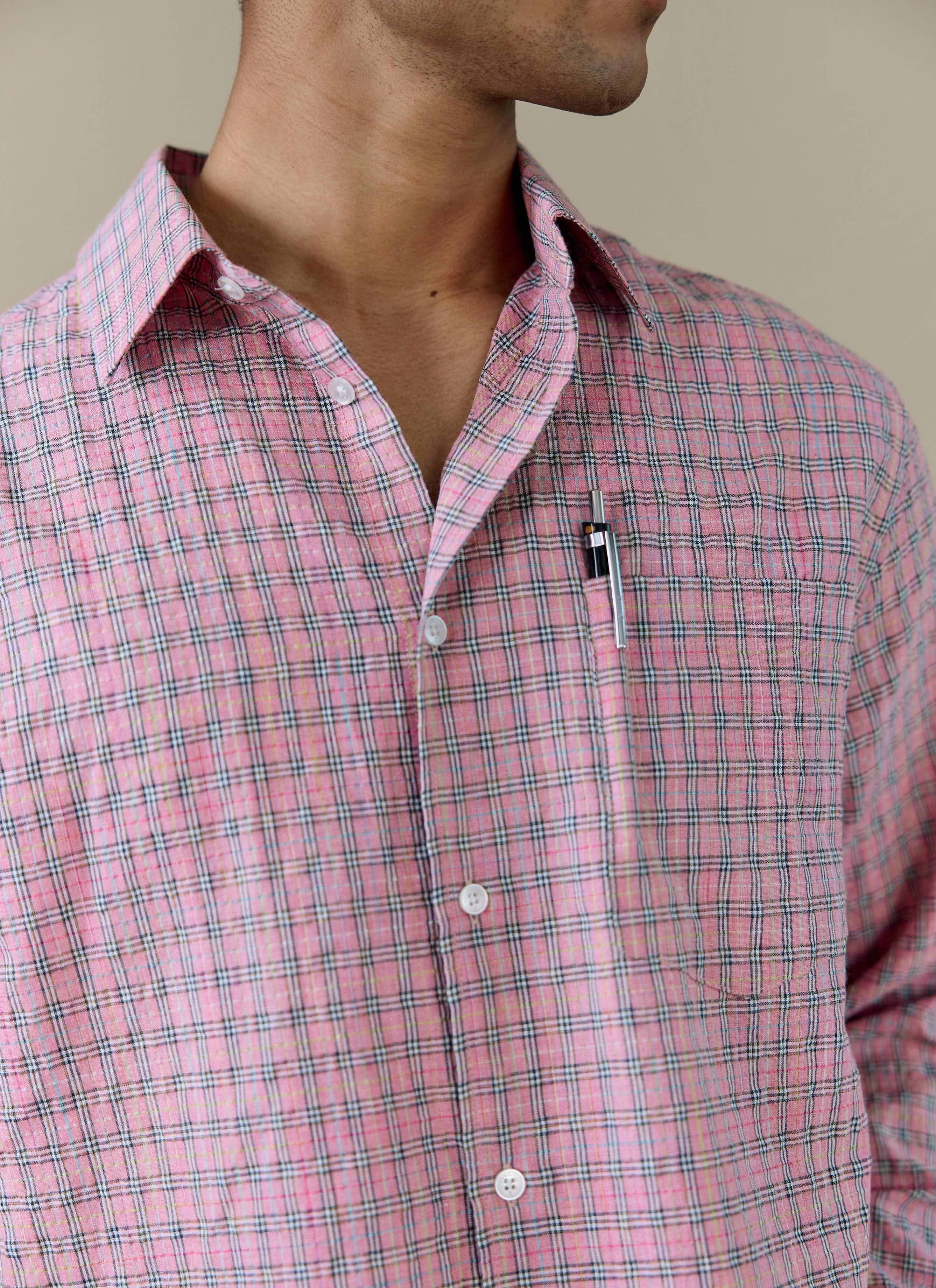 A close-up of the Percival Hinsley Checked Boxy Shirt in pink, showing the cotton check pattern and chest pocket detail.