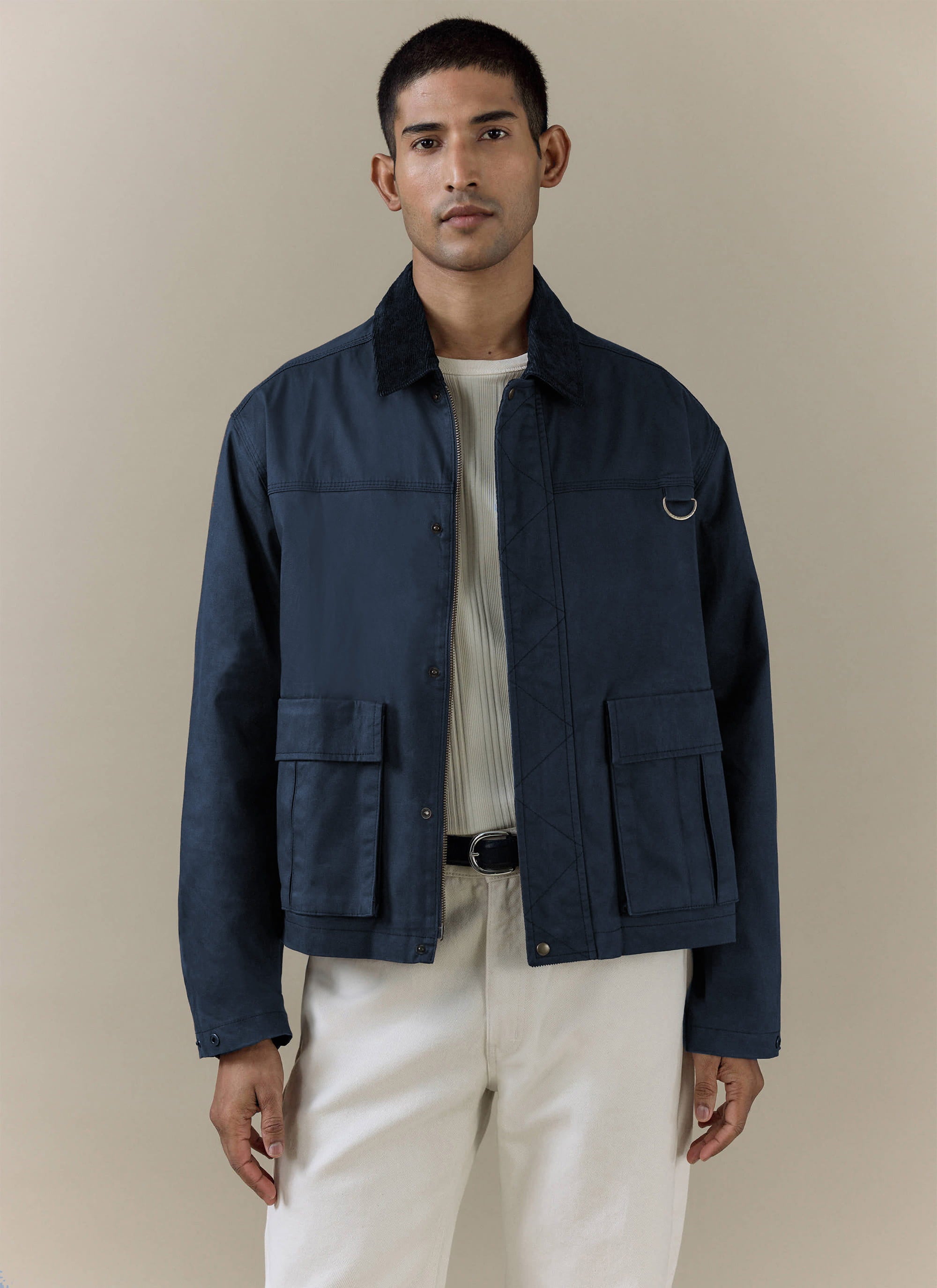 Navy blue Percival Wax Zip Jacket in waxed cotton, featuring a corduroy collar, zip front, and large patch pockets.