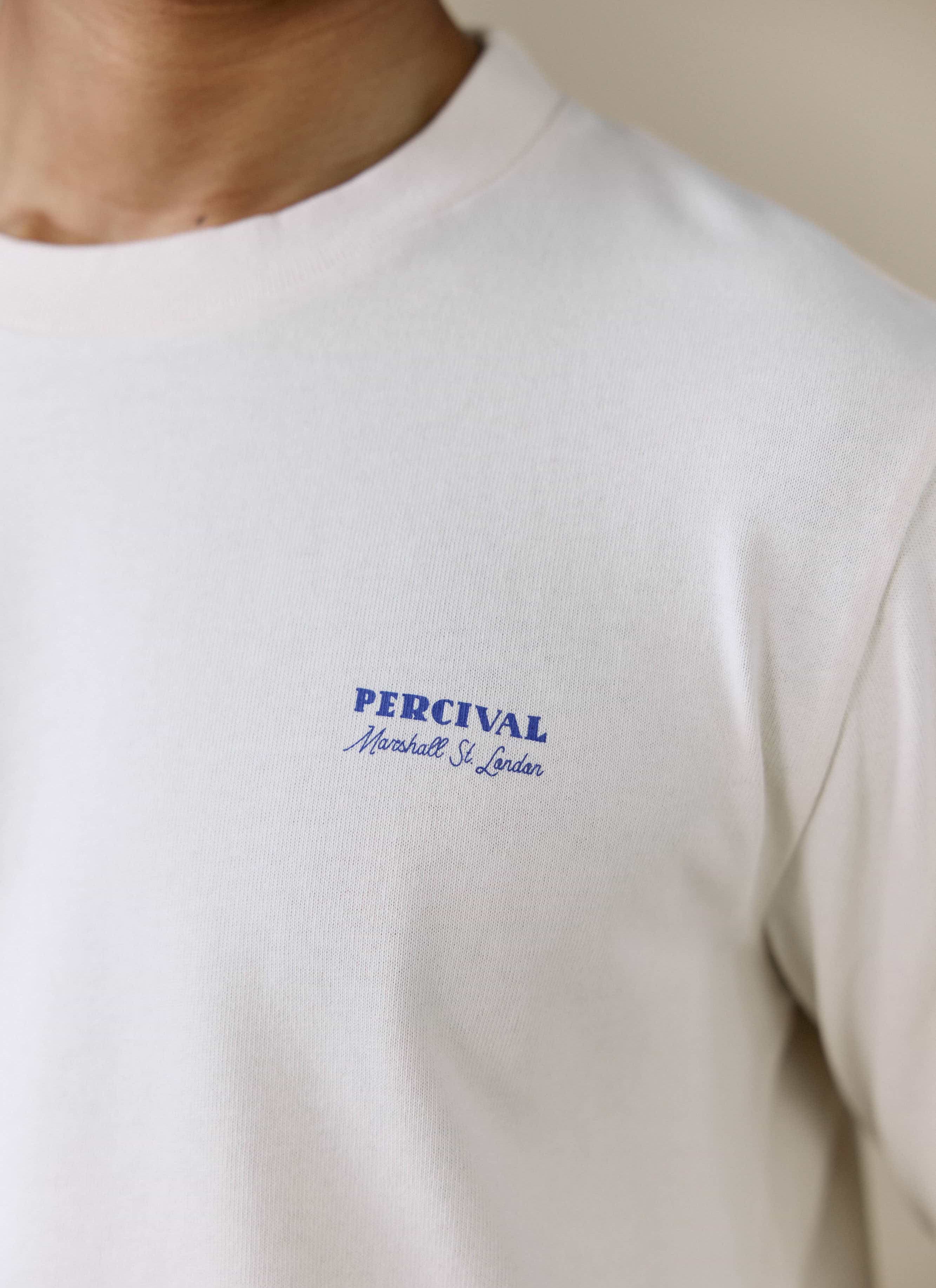 A close-up of the blue Percival Marshall St. London graphic on the chest of the cream Harlow Fine Wines long sleeve T shirt.