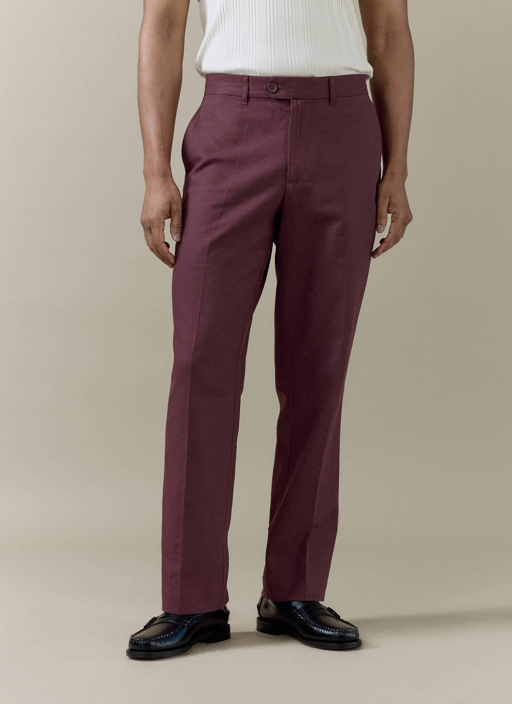 A model wearing Percival Tailored Linen Trousers in Merlot, featuring a straight leg and sharp pressed crease.