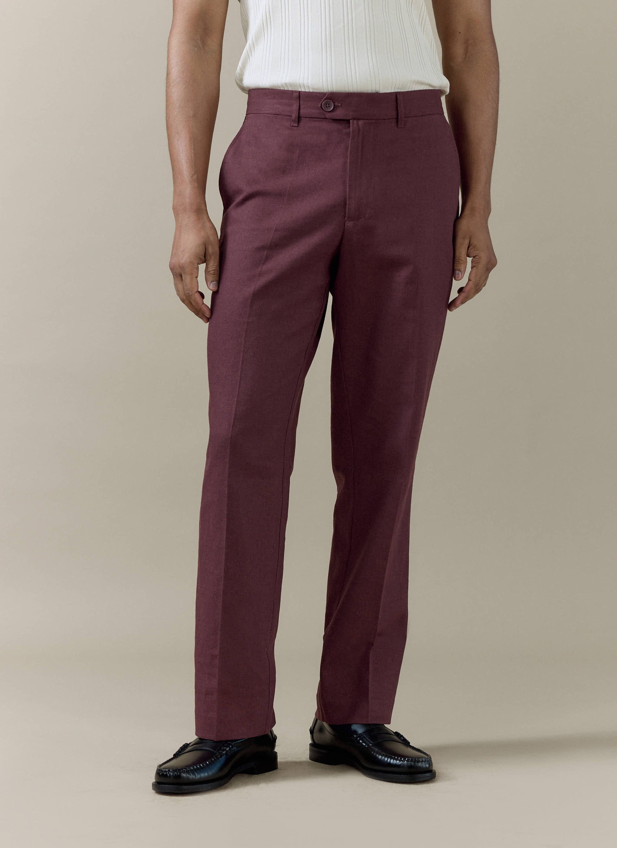 A model wearing Percival Tailored Linen Trousers in Merlot, featuring a straight leg and sharp pressed crease.