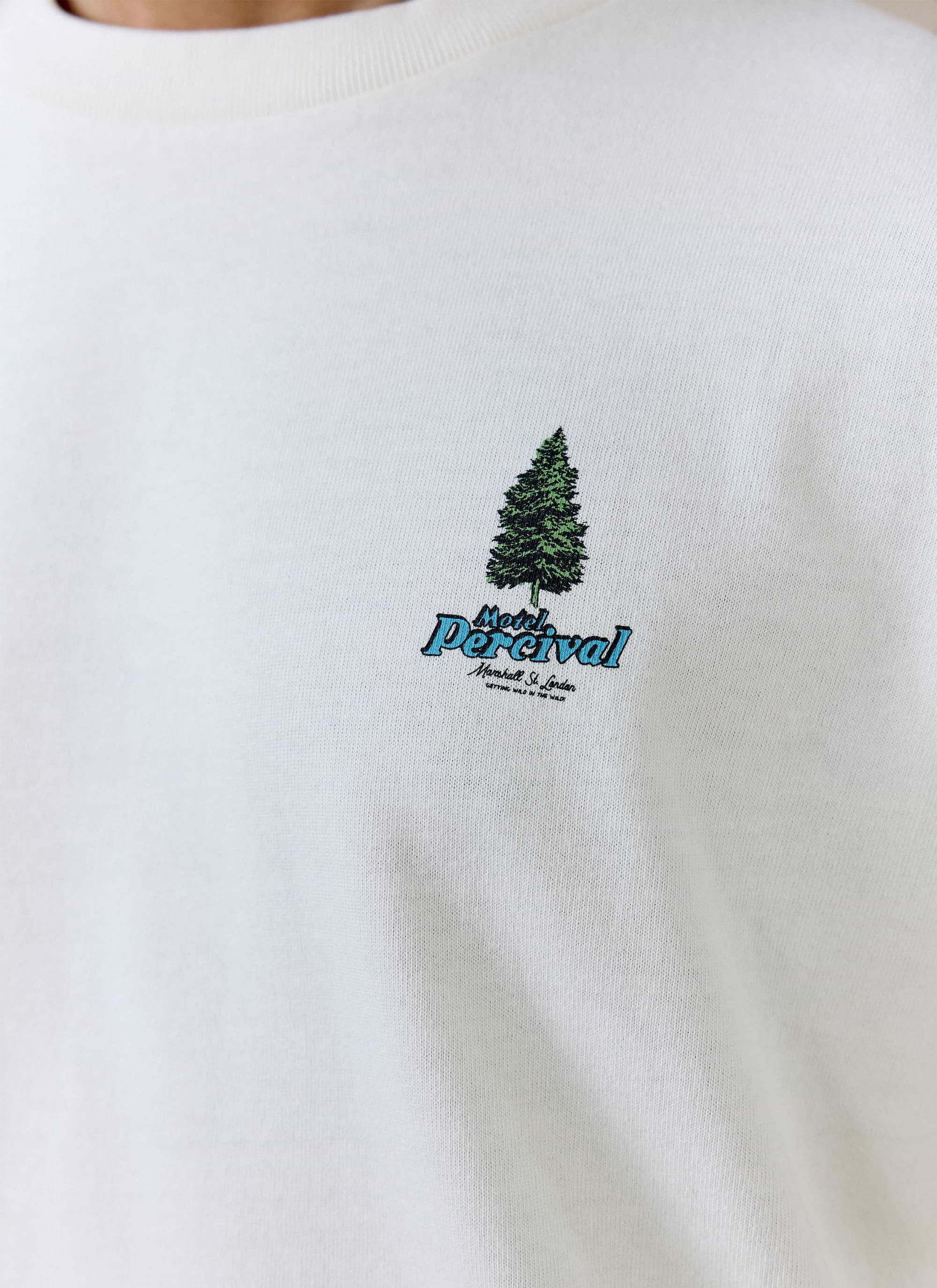 Close-up of the blue Motel Percival graphic and pine tree on the cream organic cotton Arnold Oversized T Shirt.