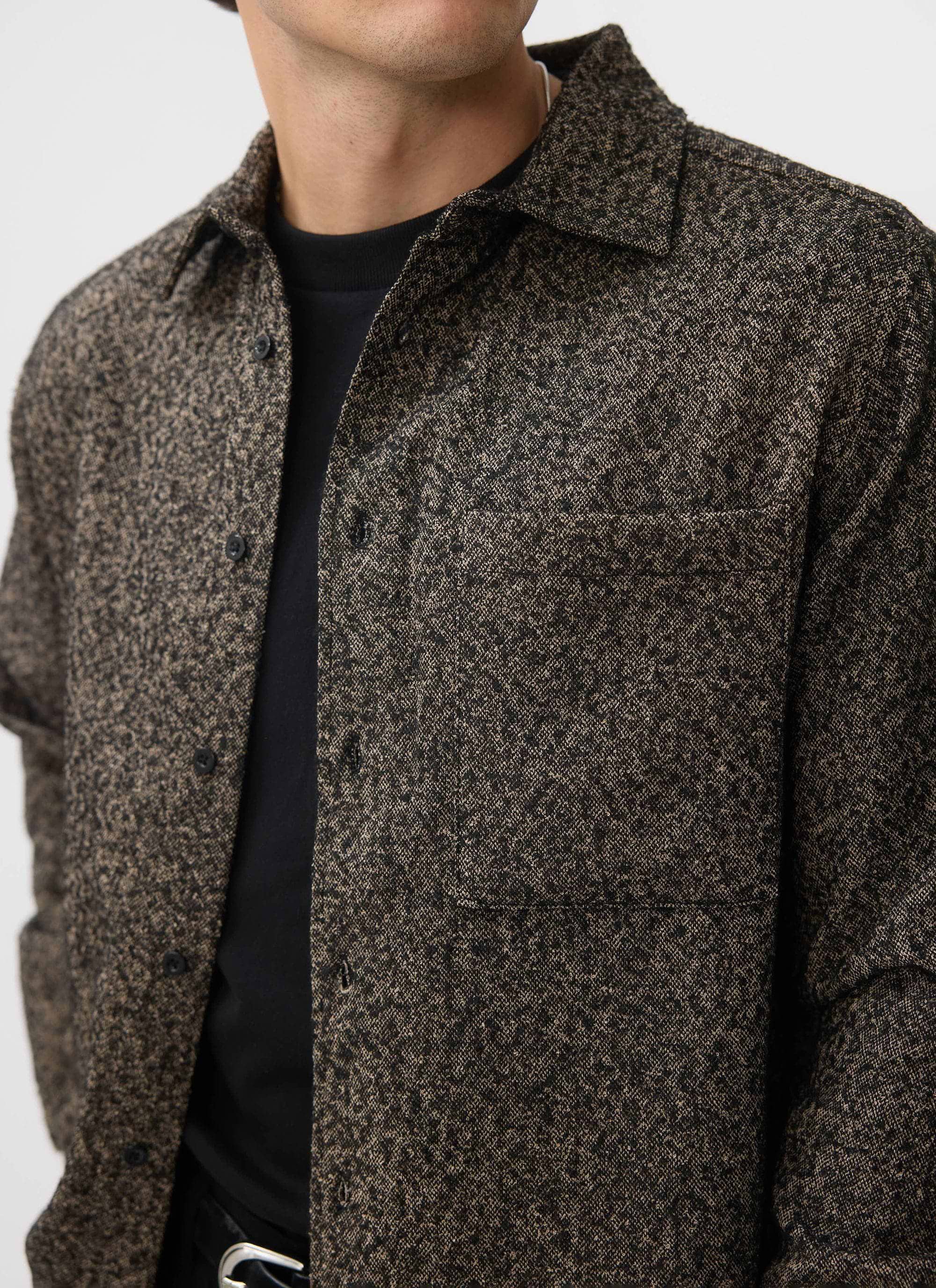 A close up of the Percival Blyton Long Sleeve Shirt in grey, highlighting the warm nep fabric texture and chest pocket.