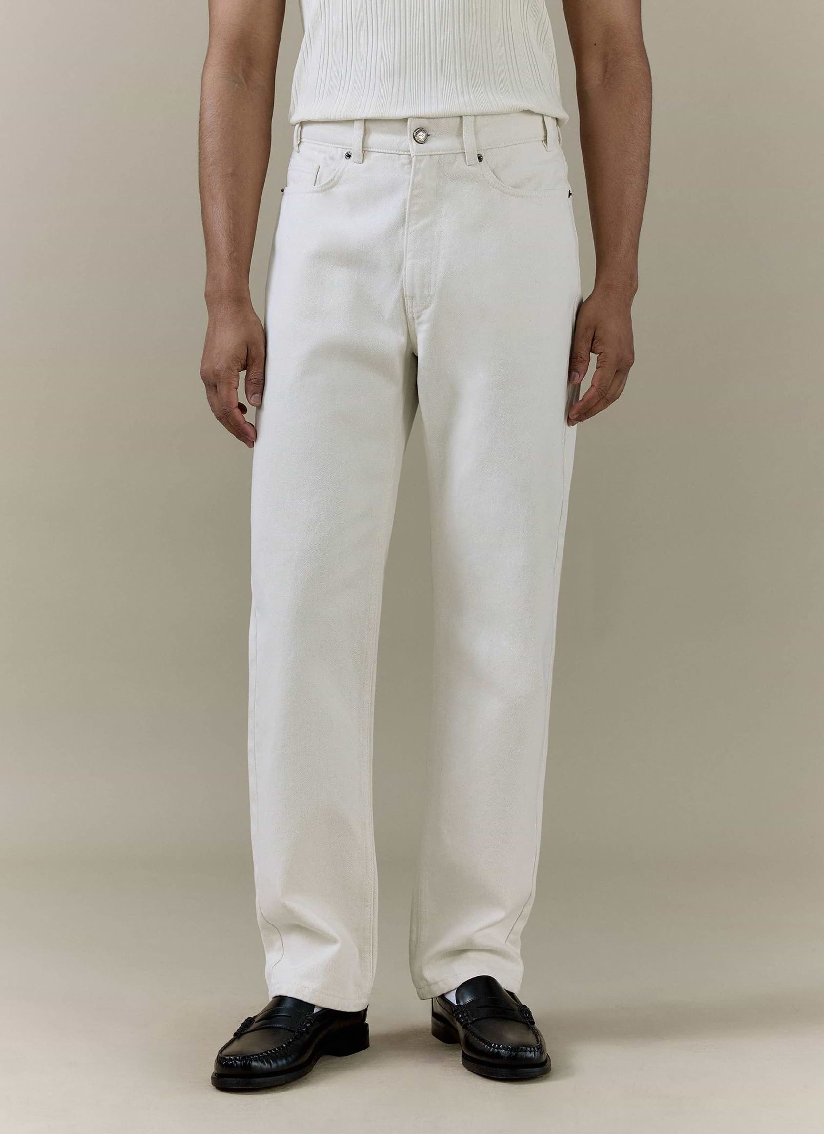 Cream Percival straight leg denim jeans in 14oz cotton, styled on a model with black leather loafers.