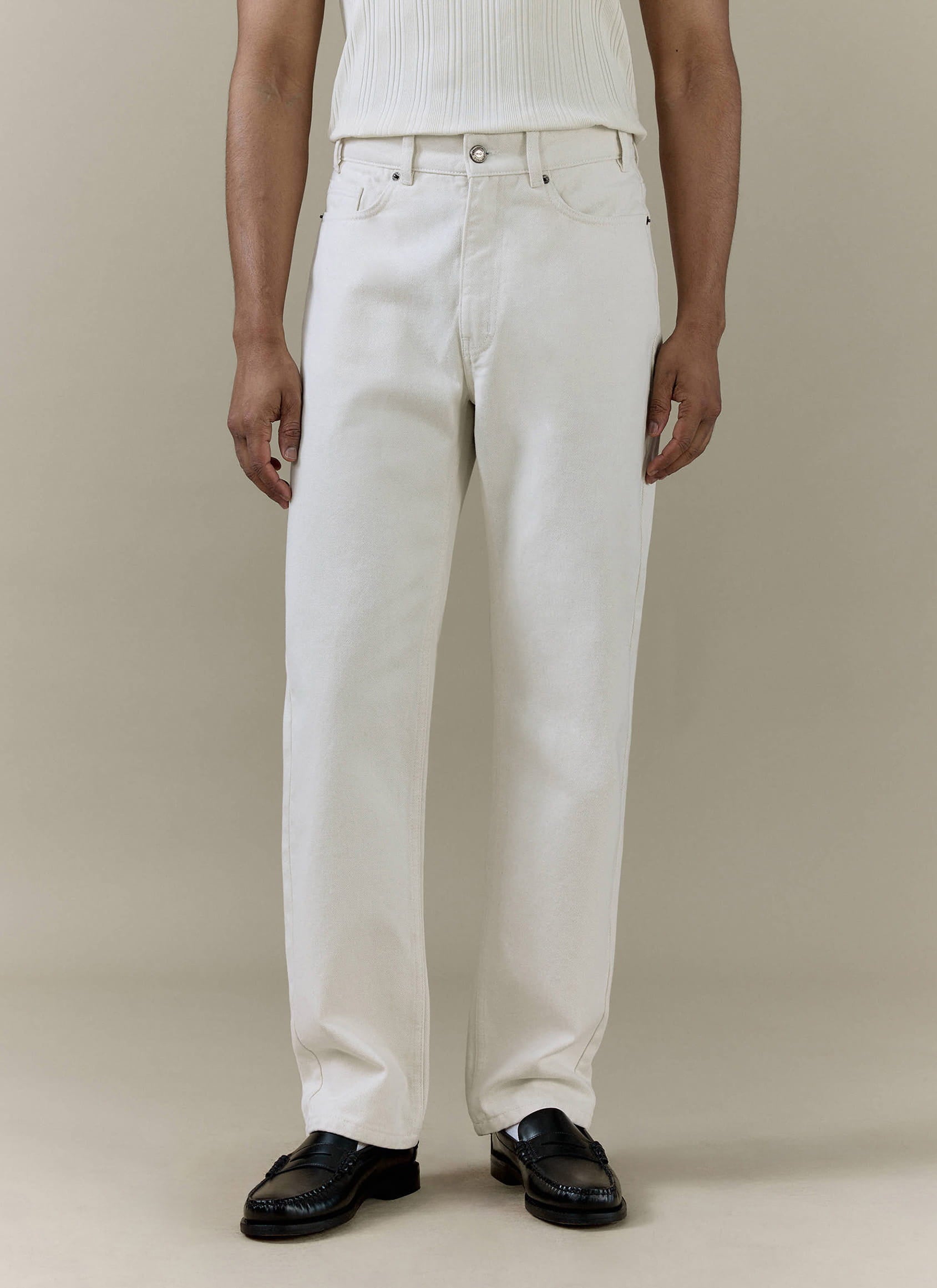 Cream Percival straight leg denim jeans in 14oz cotton, styled on a model with black leather loafers.