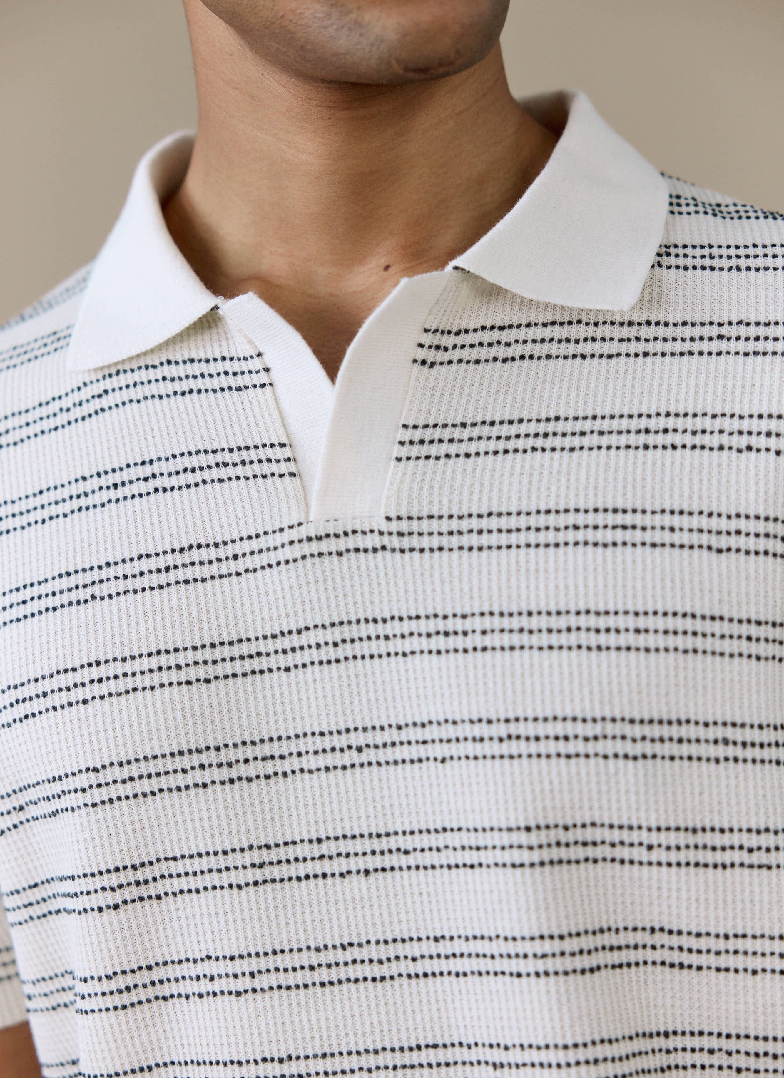 Close-up of the Percival Laurent Boxy Polo in cream, showing the open collar and horizontal striped cotton knit.