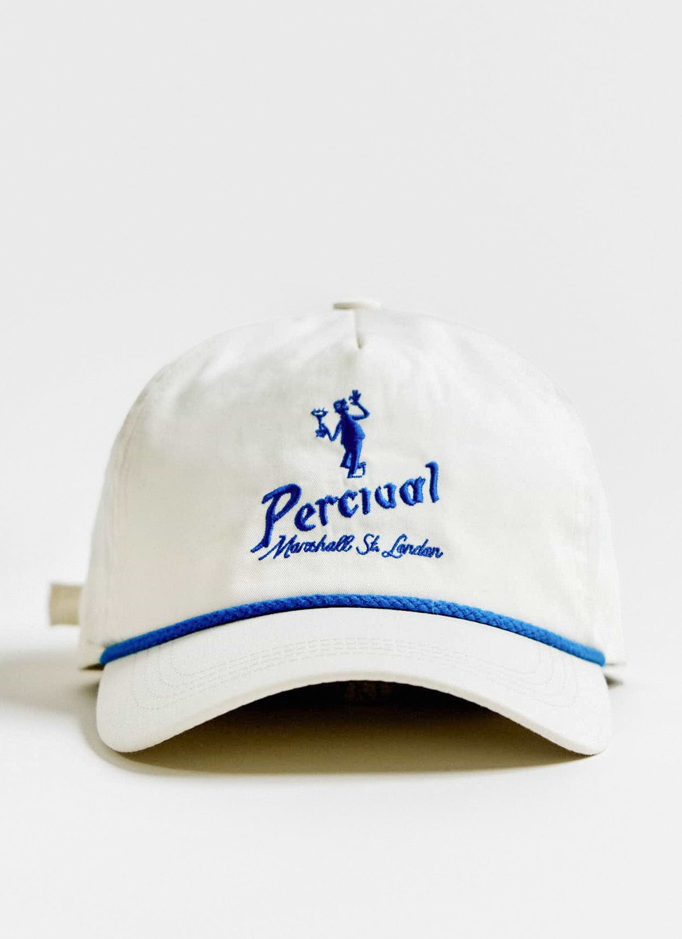 Front view of the cream Percival Martini Soft Trucker Cap, showing the blue embroidery and contrast rope detail.