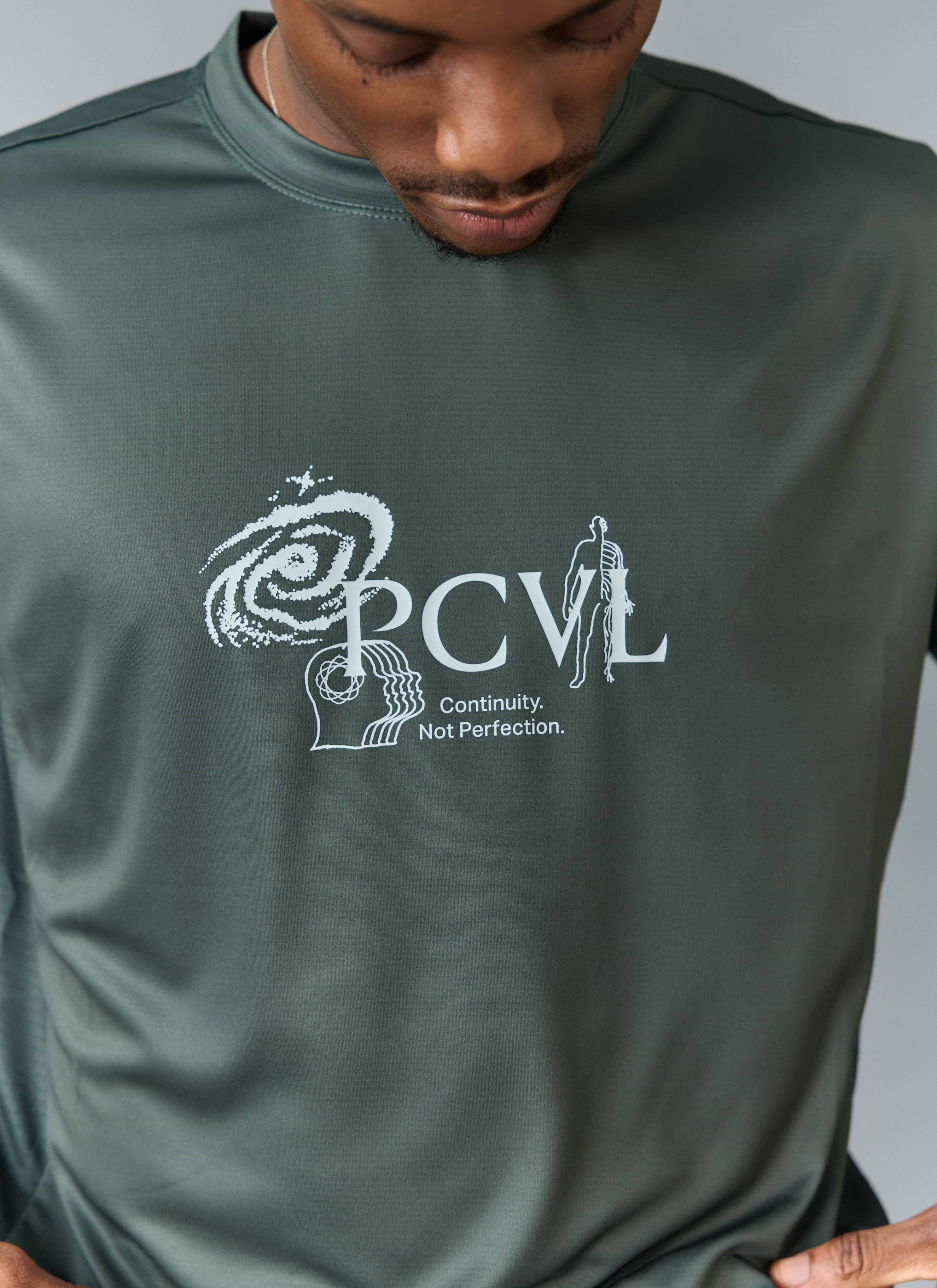 A close-up of the white 'PCVL' graphic on the chest of the forest green Percival Printed Performance Top.