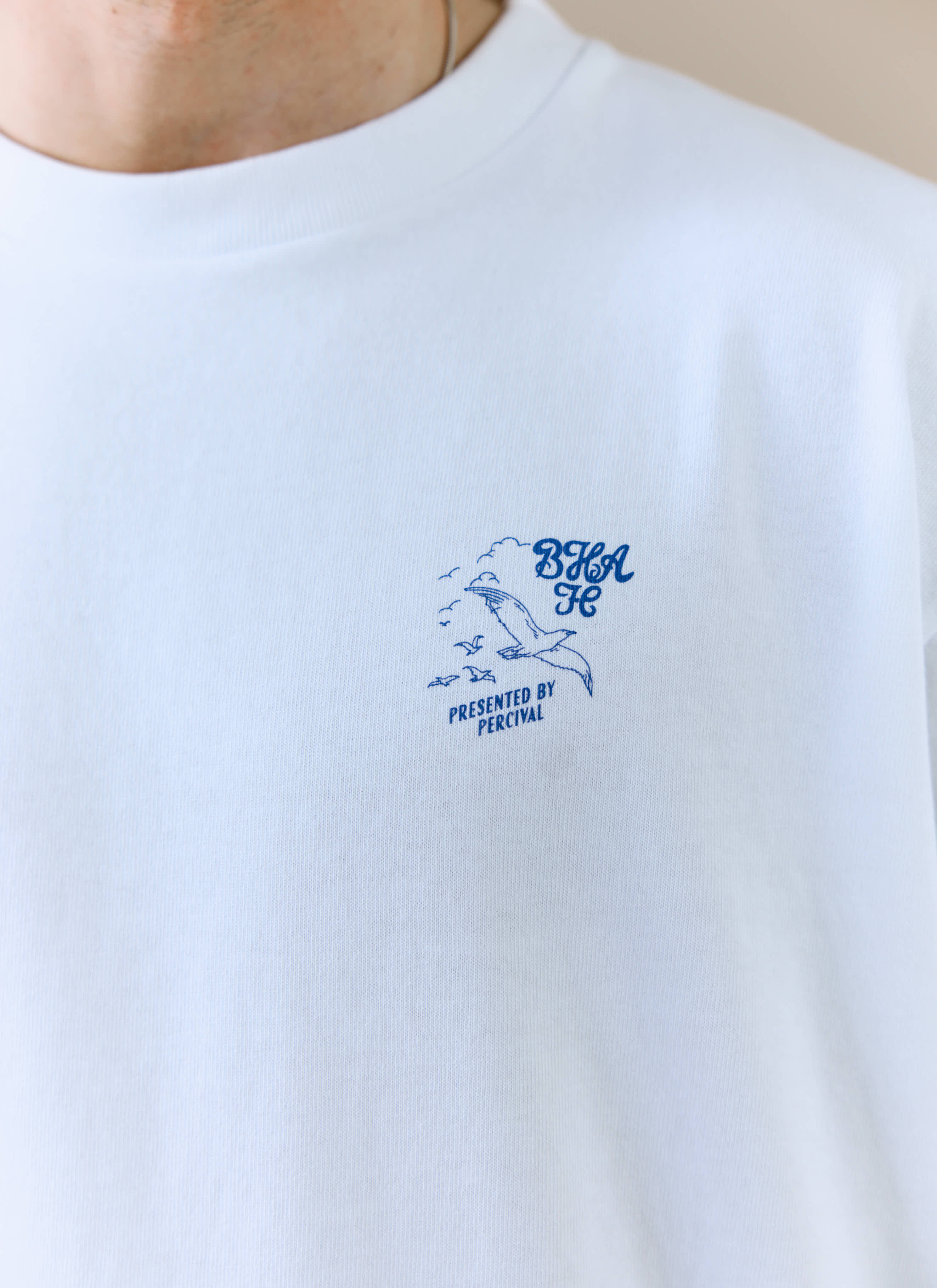 A close-up of the blue chest graphic on the white Beach Front T-shirt from the Percival x Brighton & Hove Albion F.C. range.