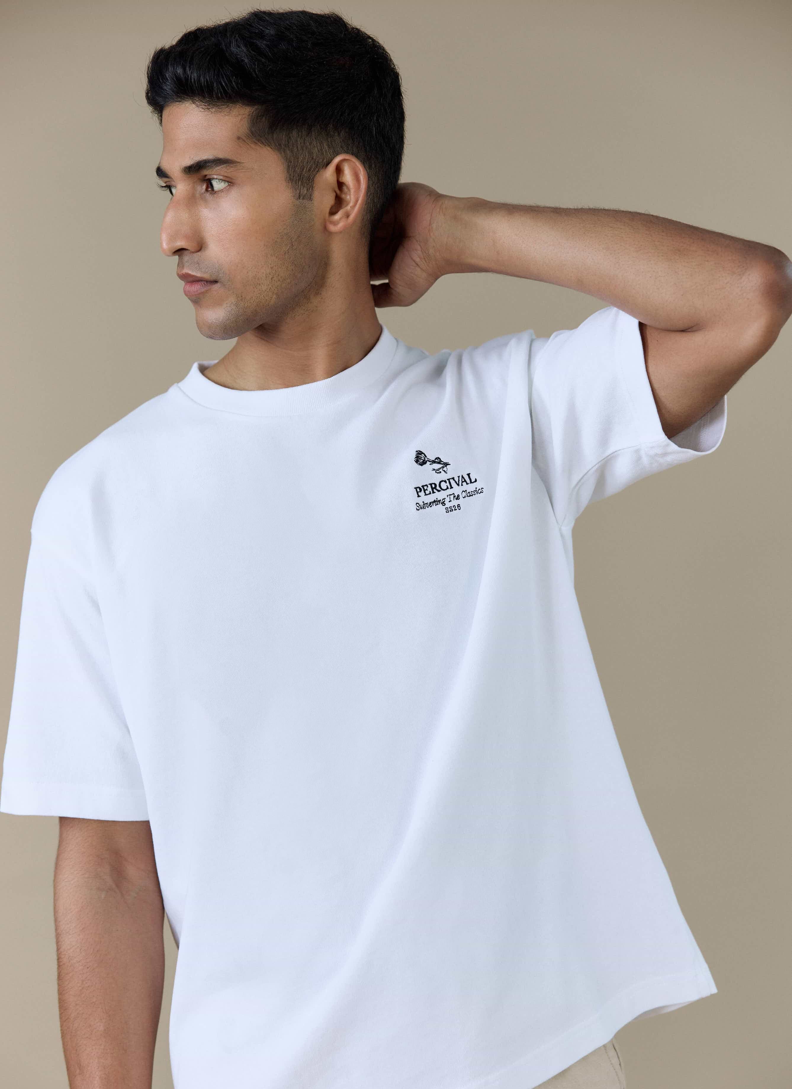 Model wearing the Percival Perci Waters Oversized T-shirt in white organic cotton, featuring the front chest embroidery.