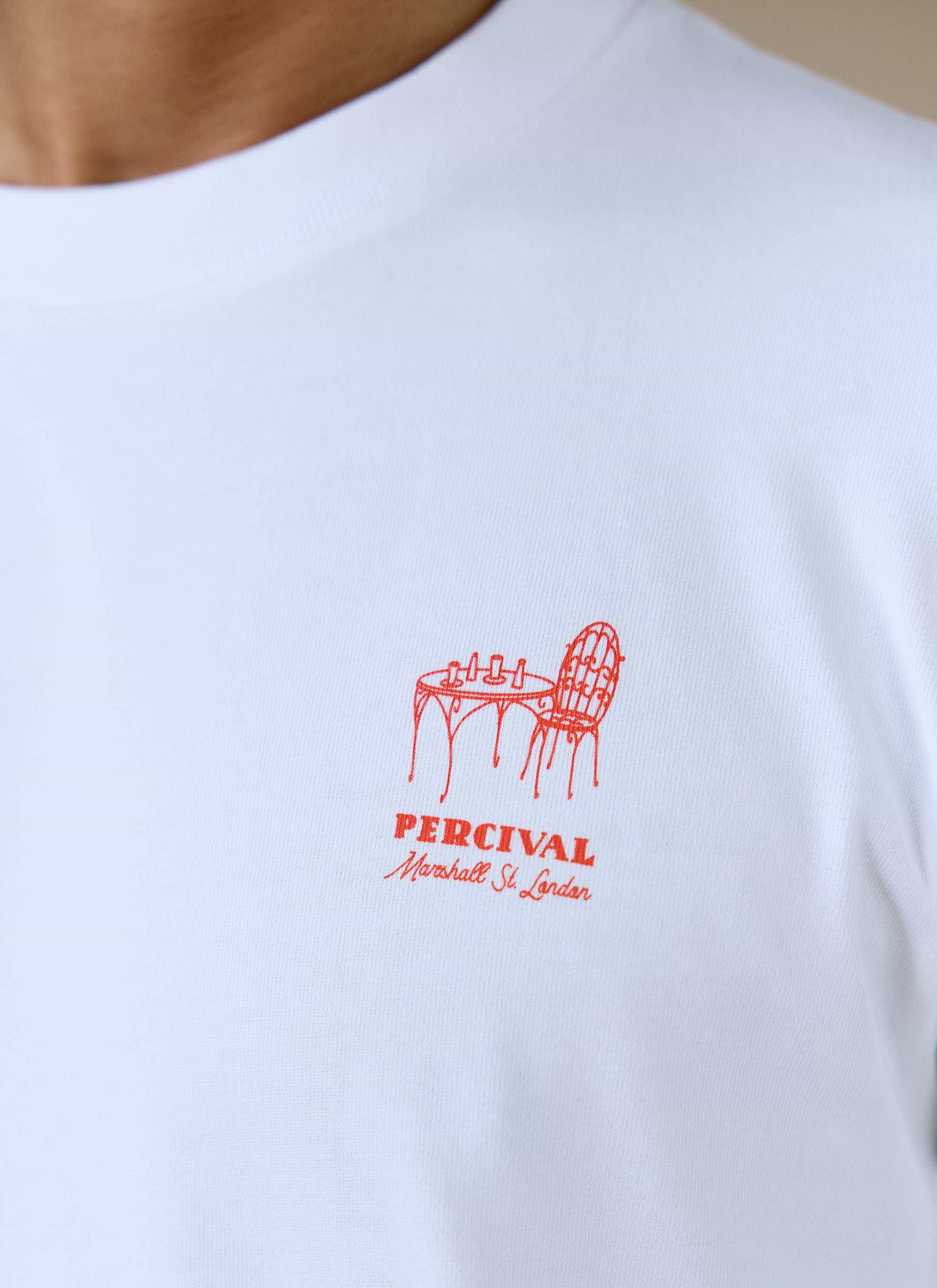 Close-up of the red bar-table chest graphic on the white organic cotton Perci Fine Wines T Shirt from Percival.