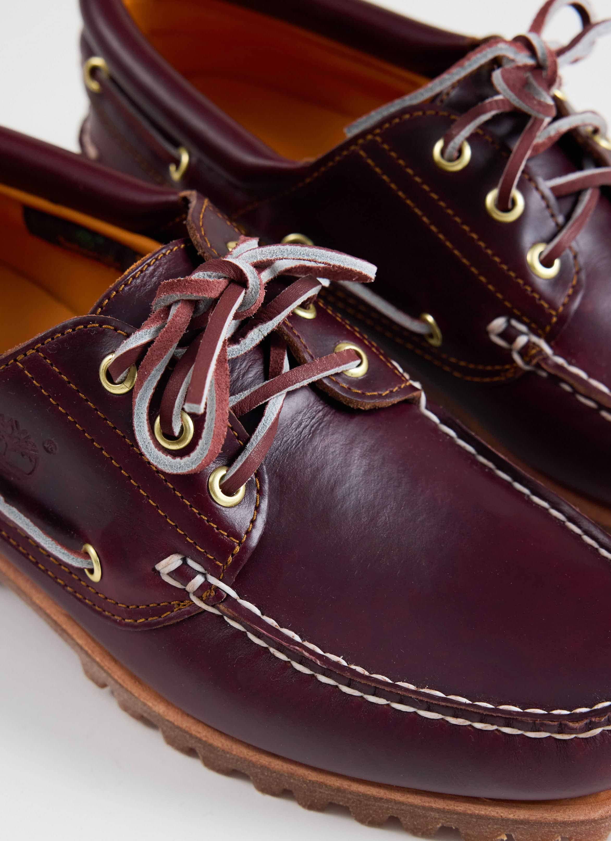 Close-up of the burgundy leather Timberland Authentic Boat Shoe at Percival, showing the handsewn rawhide lacing.