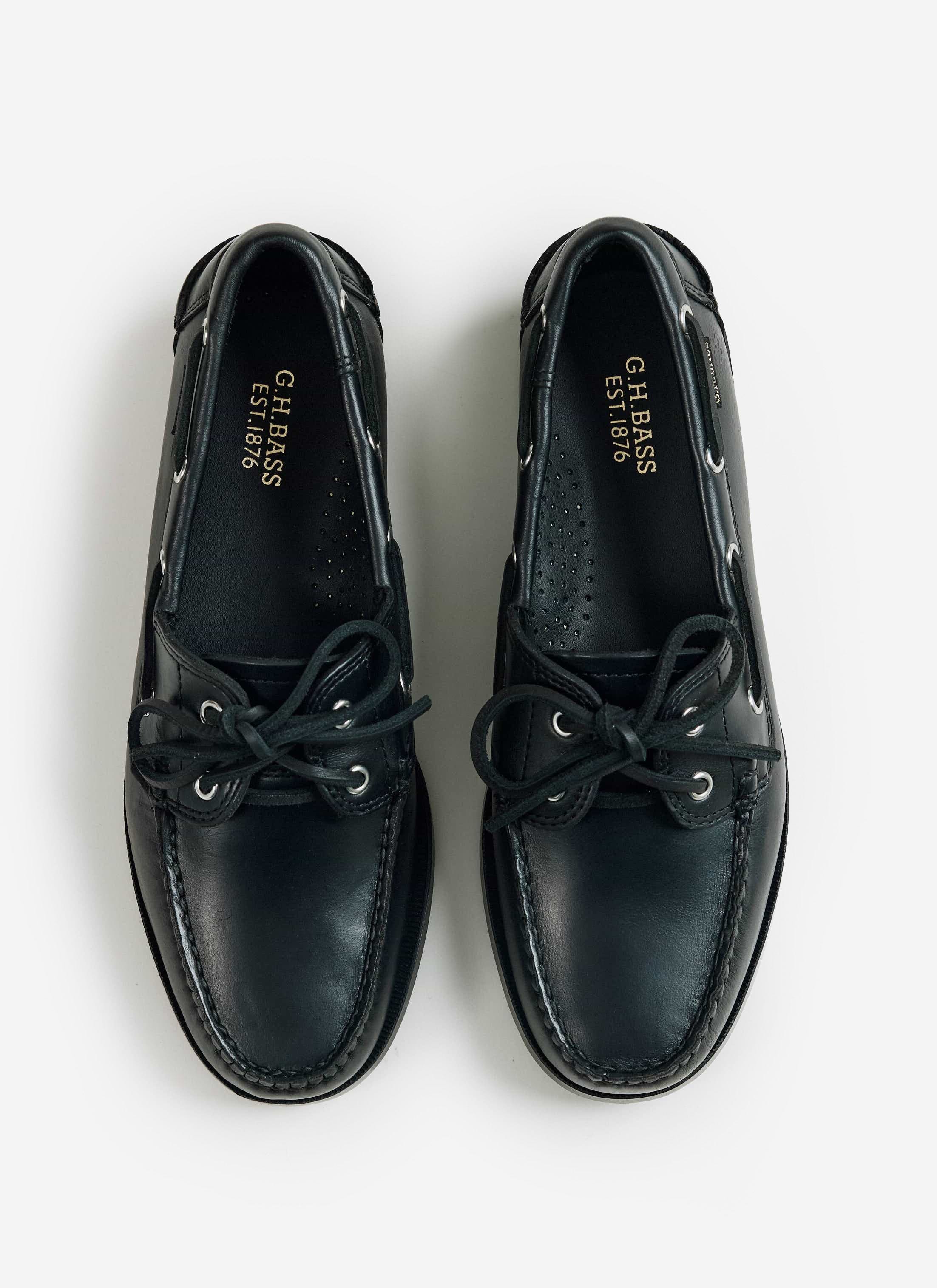 A flat lay of the black G.H. Bass Jetty II Boater 2 Eye leather shoes from Percival, showing the gold foil branding.