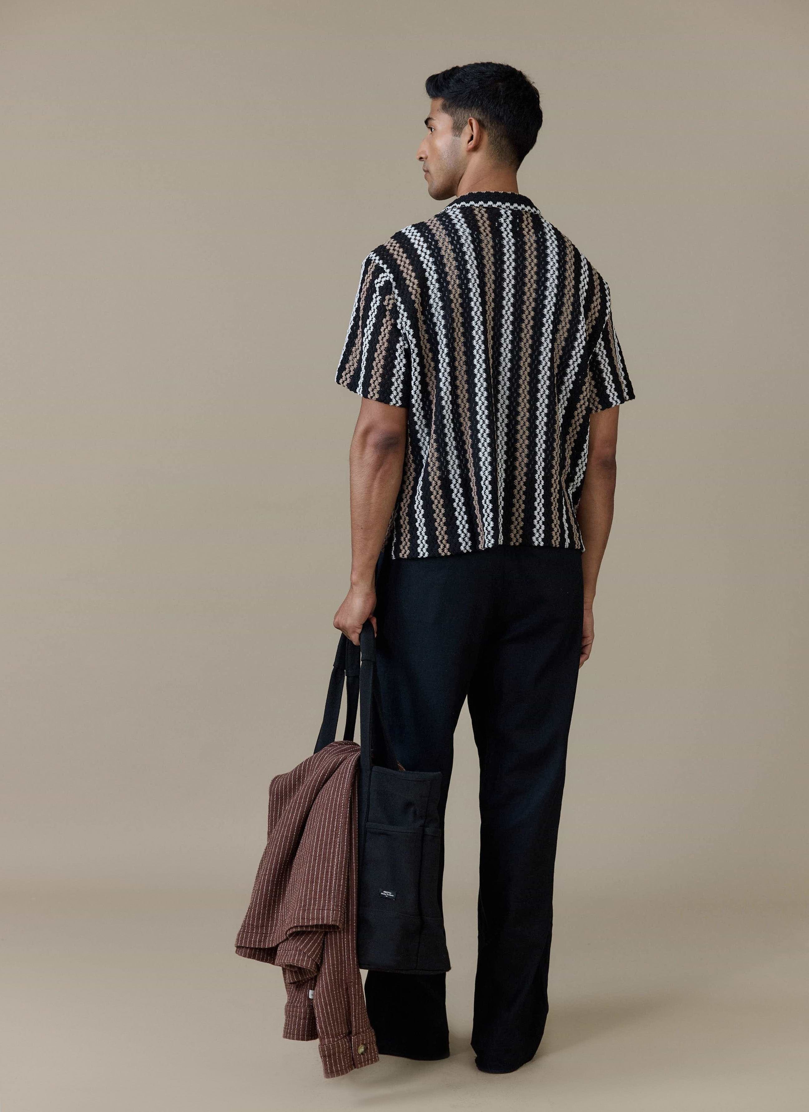 Rear view of a model wearing the Percival Wade Crochet Boxy Shirt in black, showing the textured vertical stripe pattern.